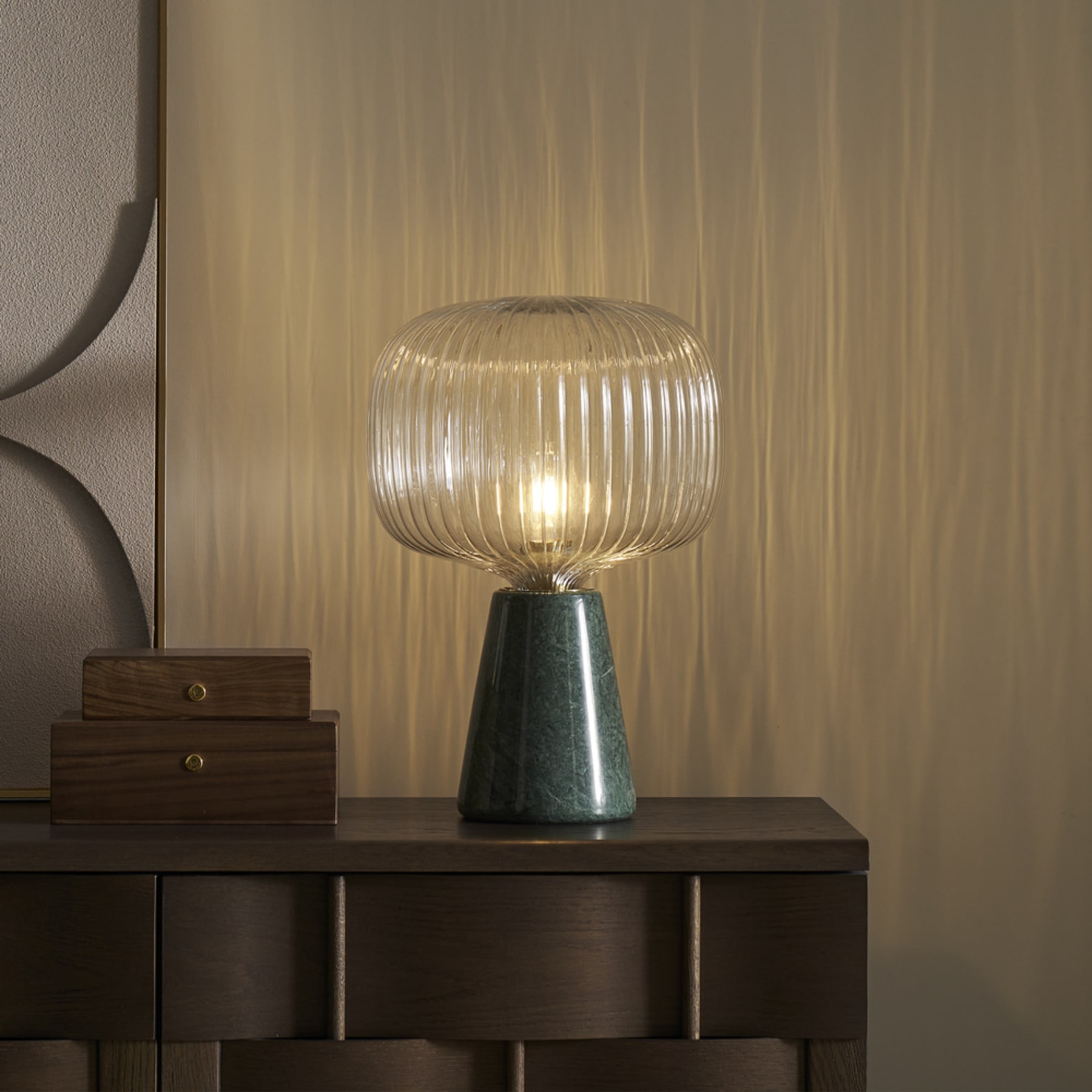 A marble table lamp with a glass lamp shade.