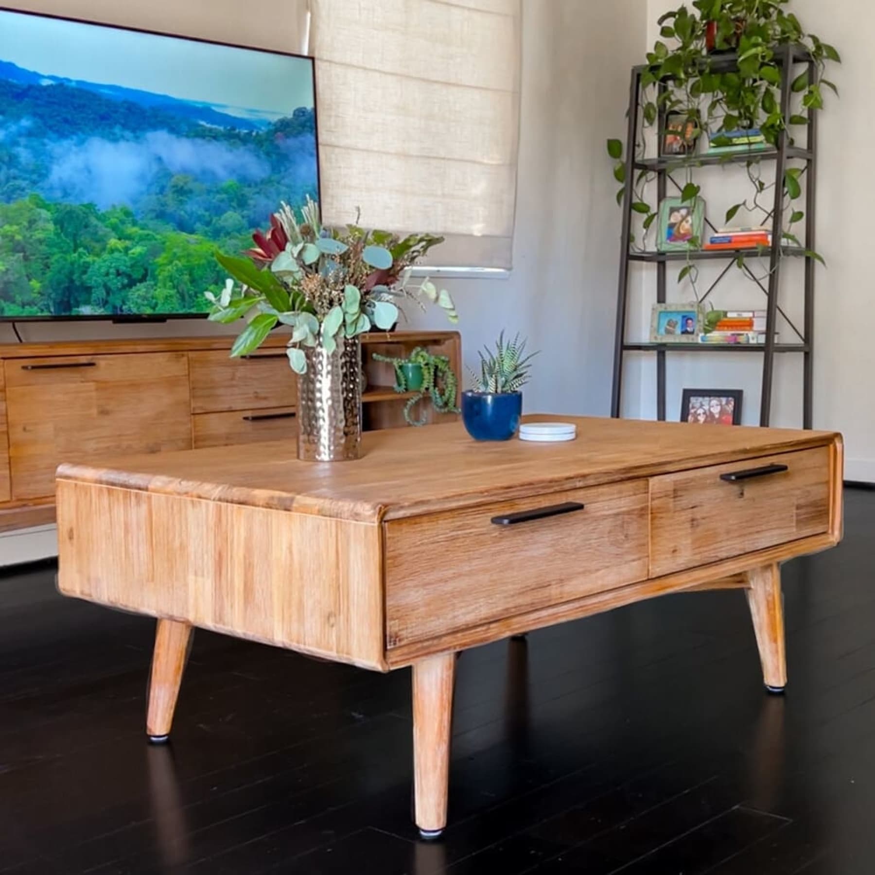 A wooden coffee table with drawers.