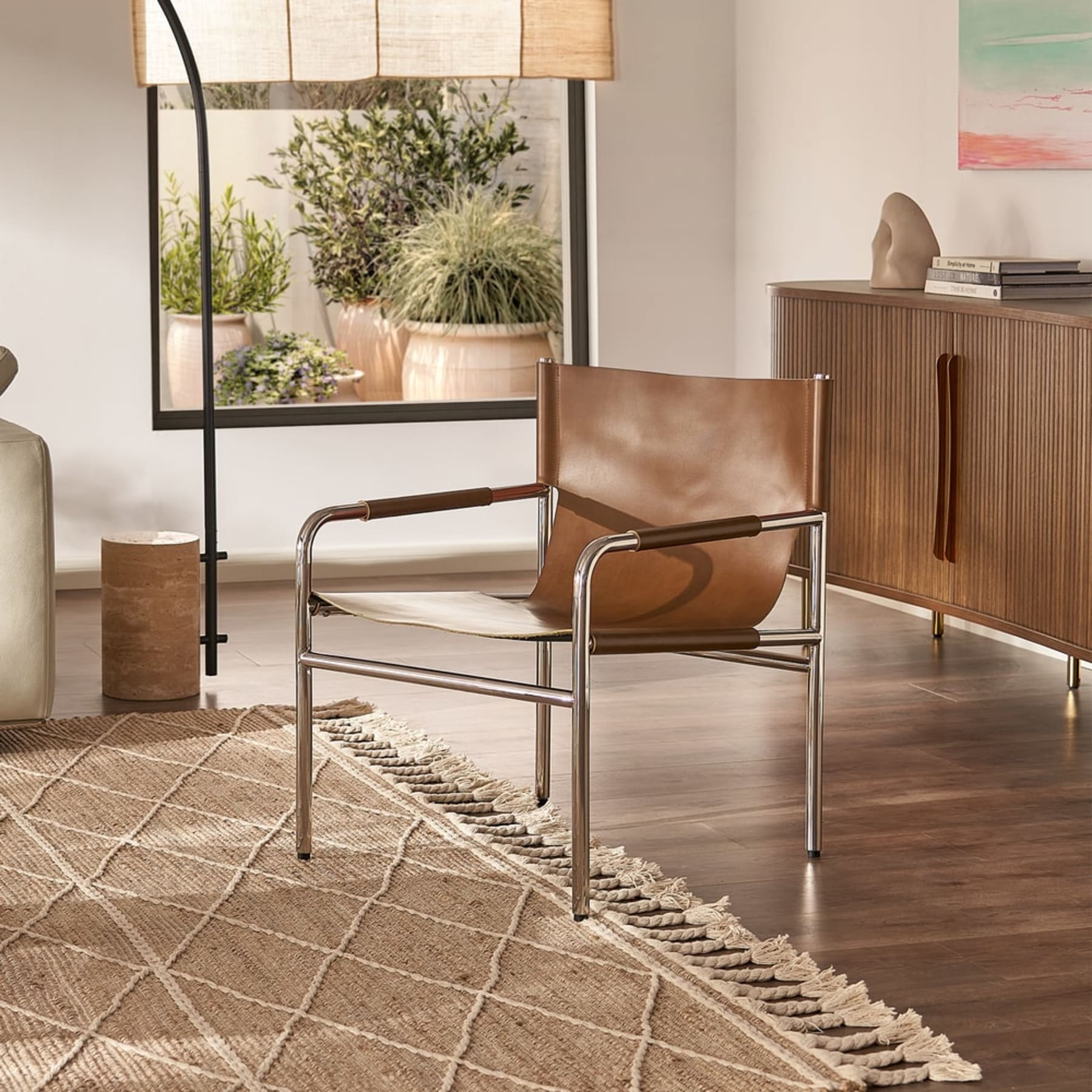 A leather sling chair in a living room.