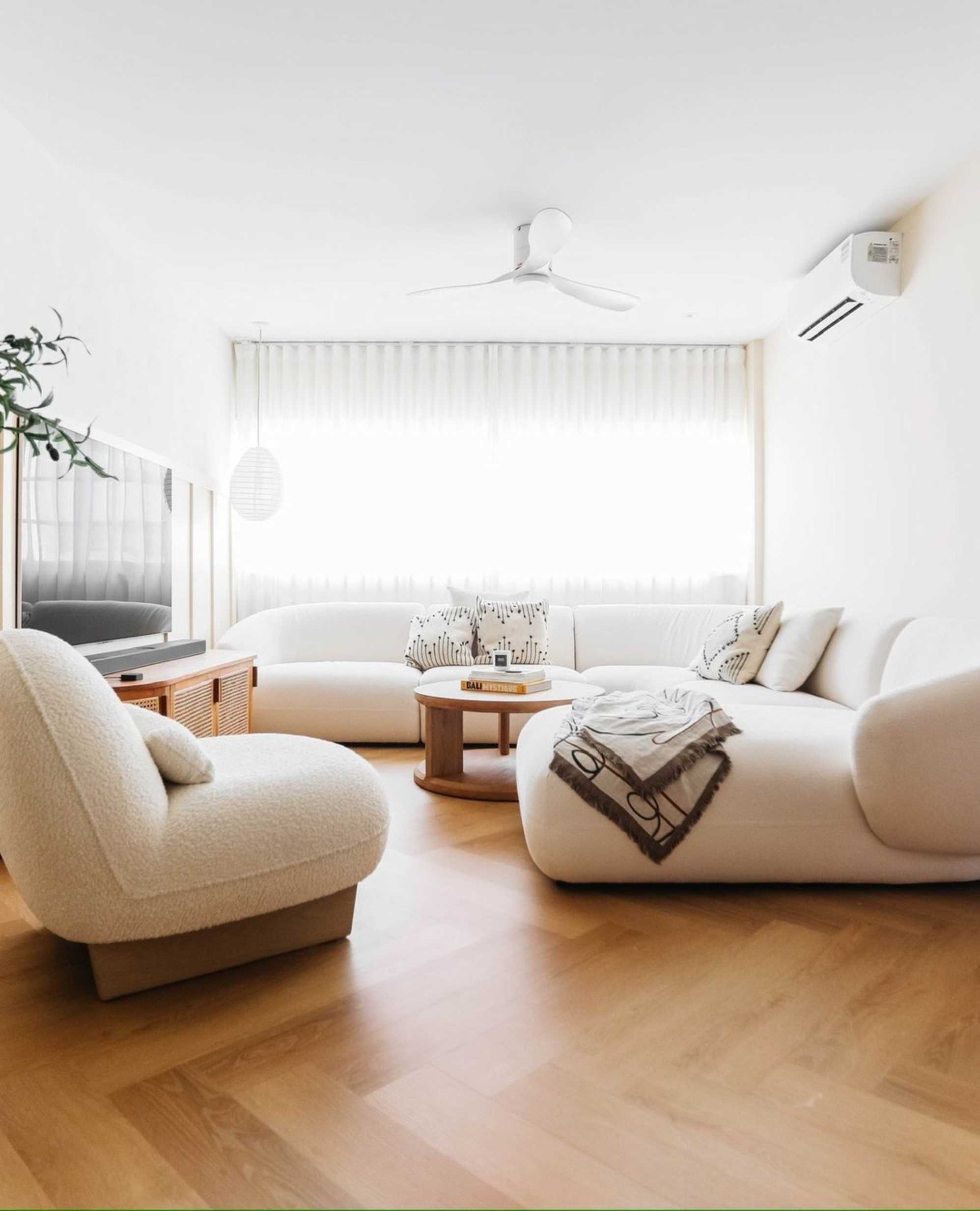 A performance fabric chaise sectional sofa and curved corner sofa placed in a living room.