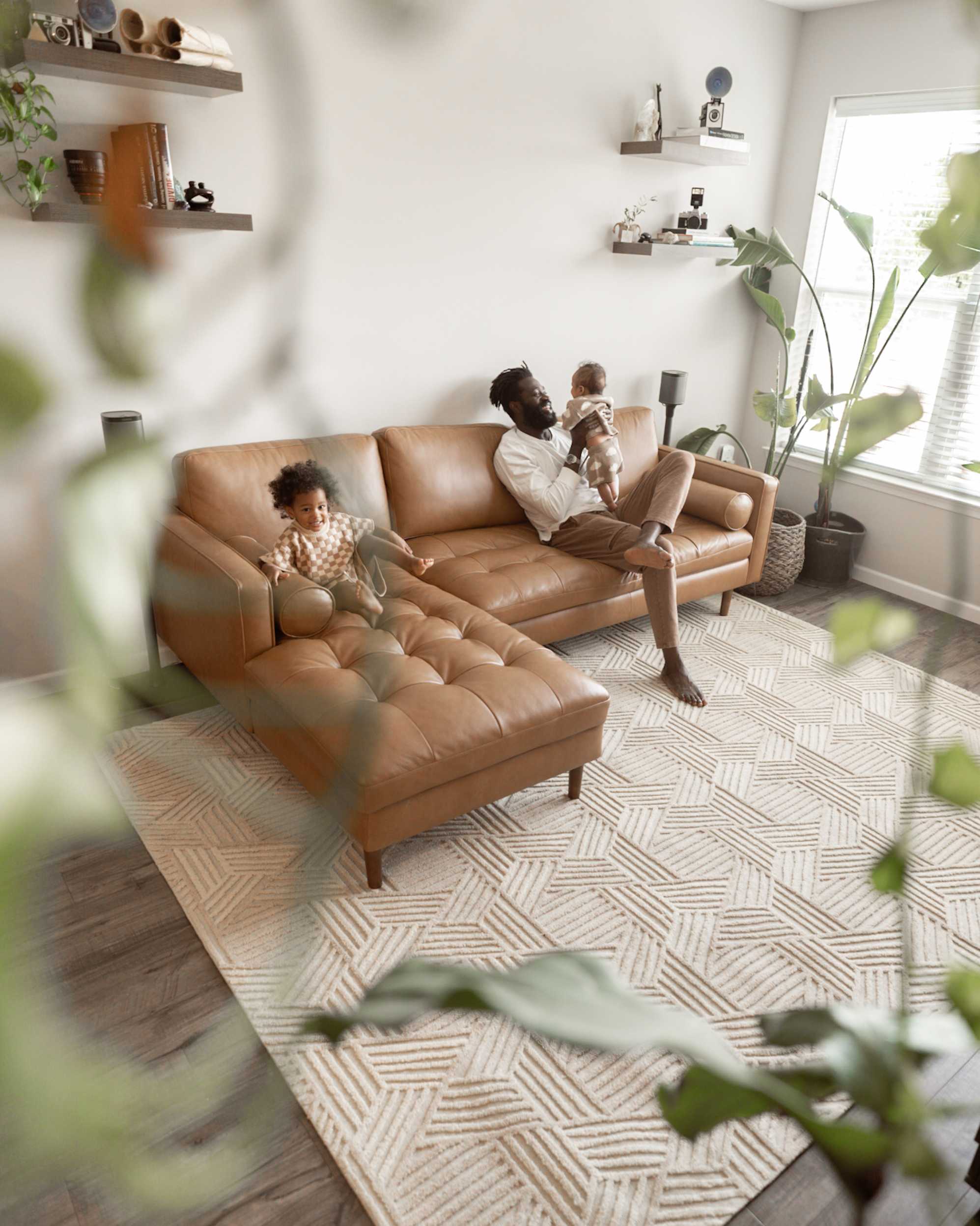 A father and his children relaxing on the Madison Leather Chaise Sectional Sofa