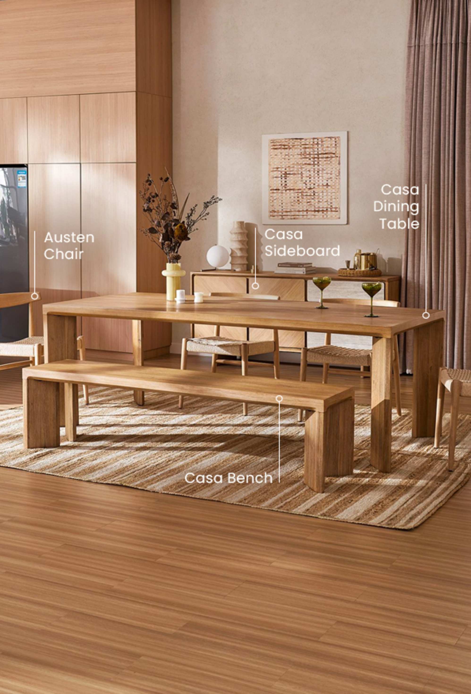 The Casa Dining Table and Casa Bench, paired with the Austen Chairs and Casa Sideboard, in a cozy, sunlit dining room