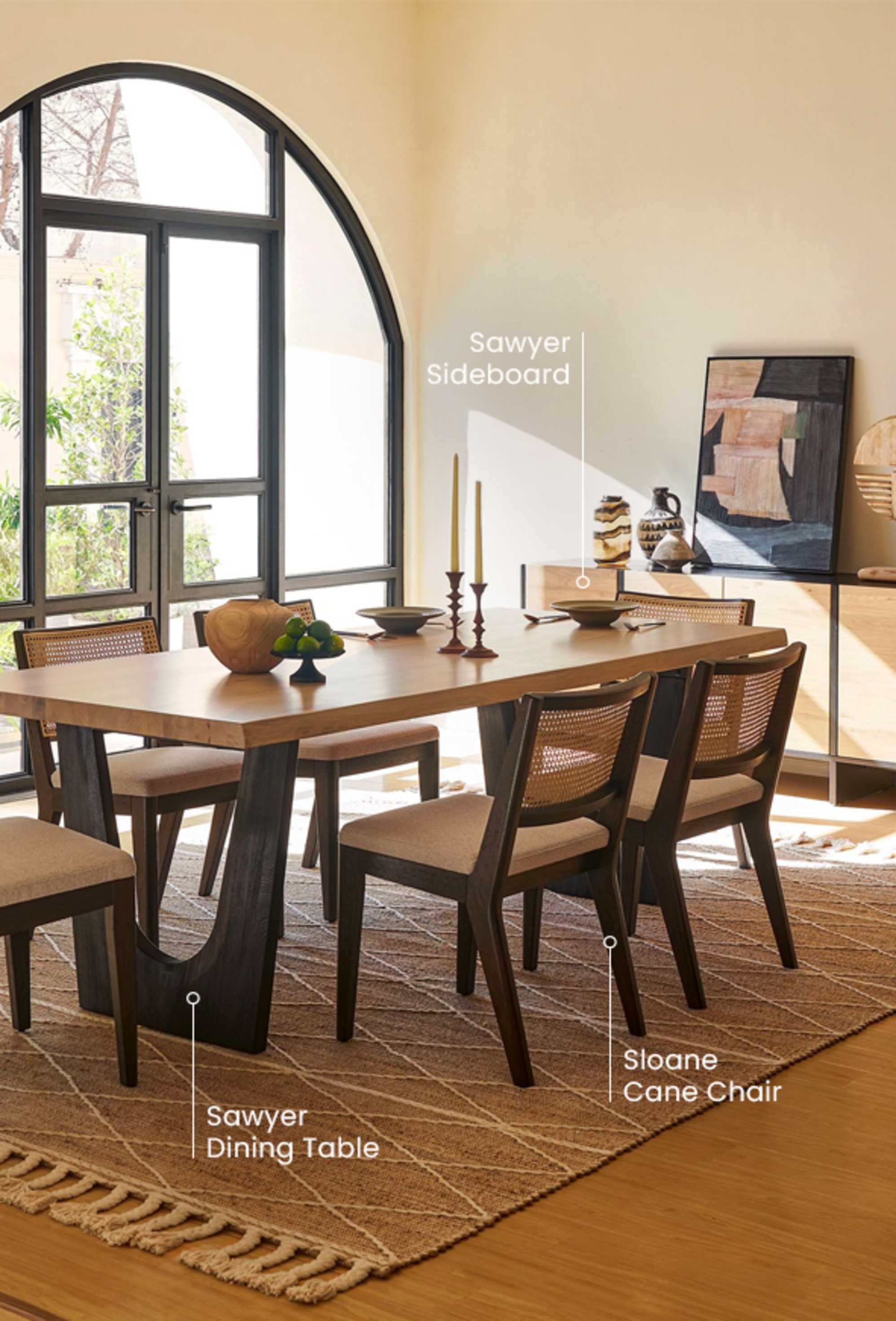 The Sawyer Dining Table and Sloane Cane Chairs paired with the Sawyer Sideboard in a modern rustic dining room