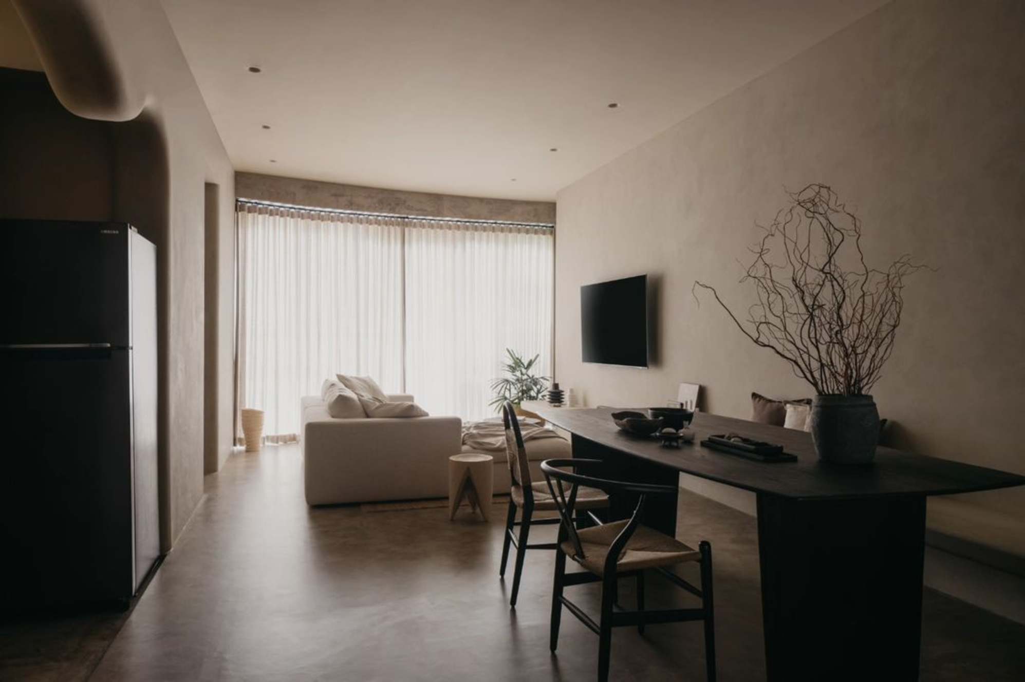A dining area next to a living room in an open floor plan.