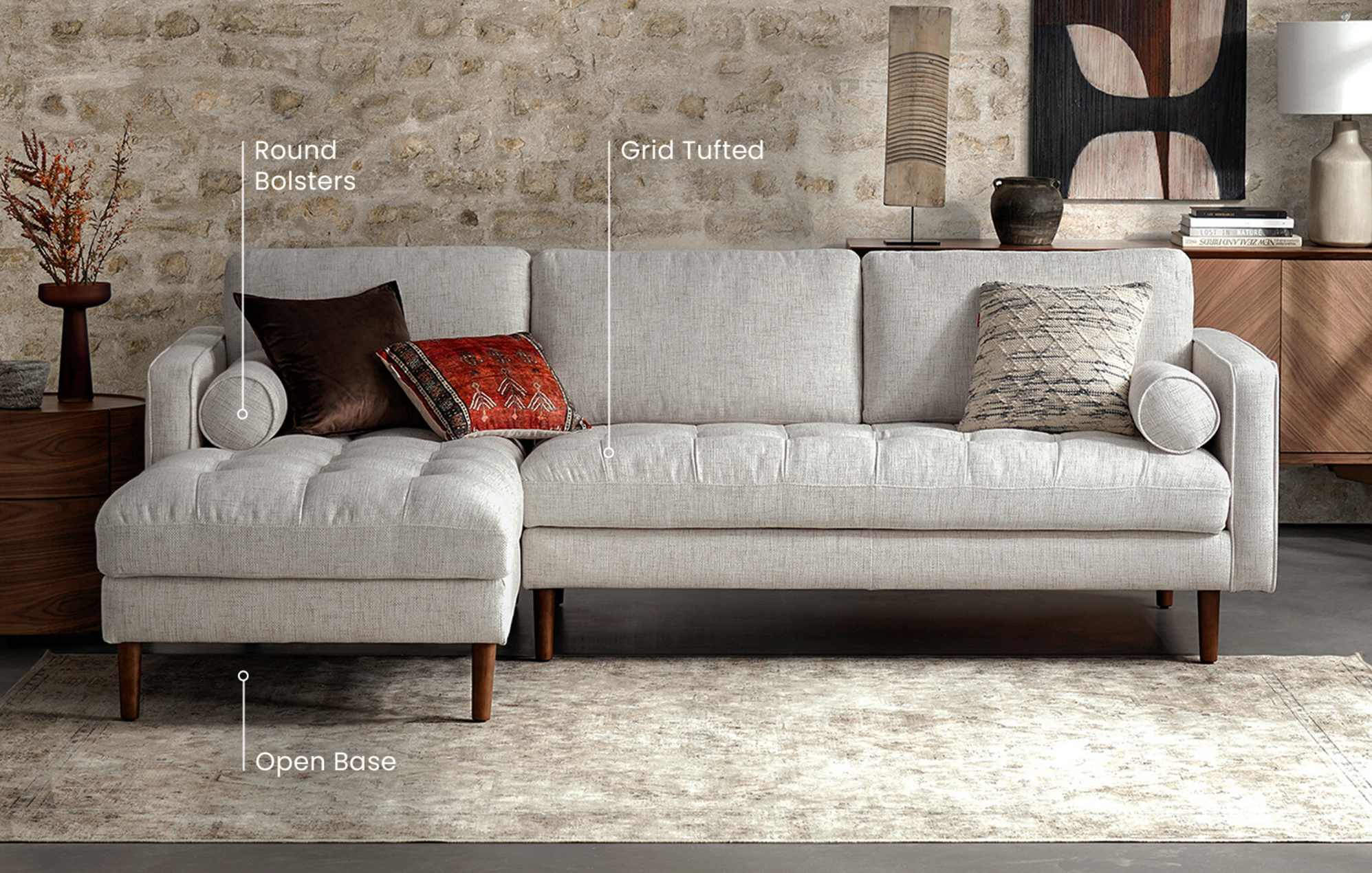 The Madison Chaise Sectional in Bisque, with text bubbles that say open base, round bolsters, and grid tufted