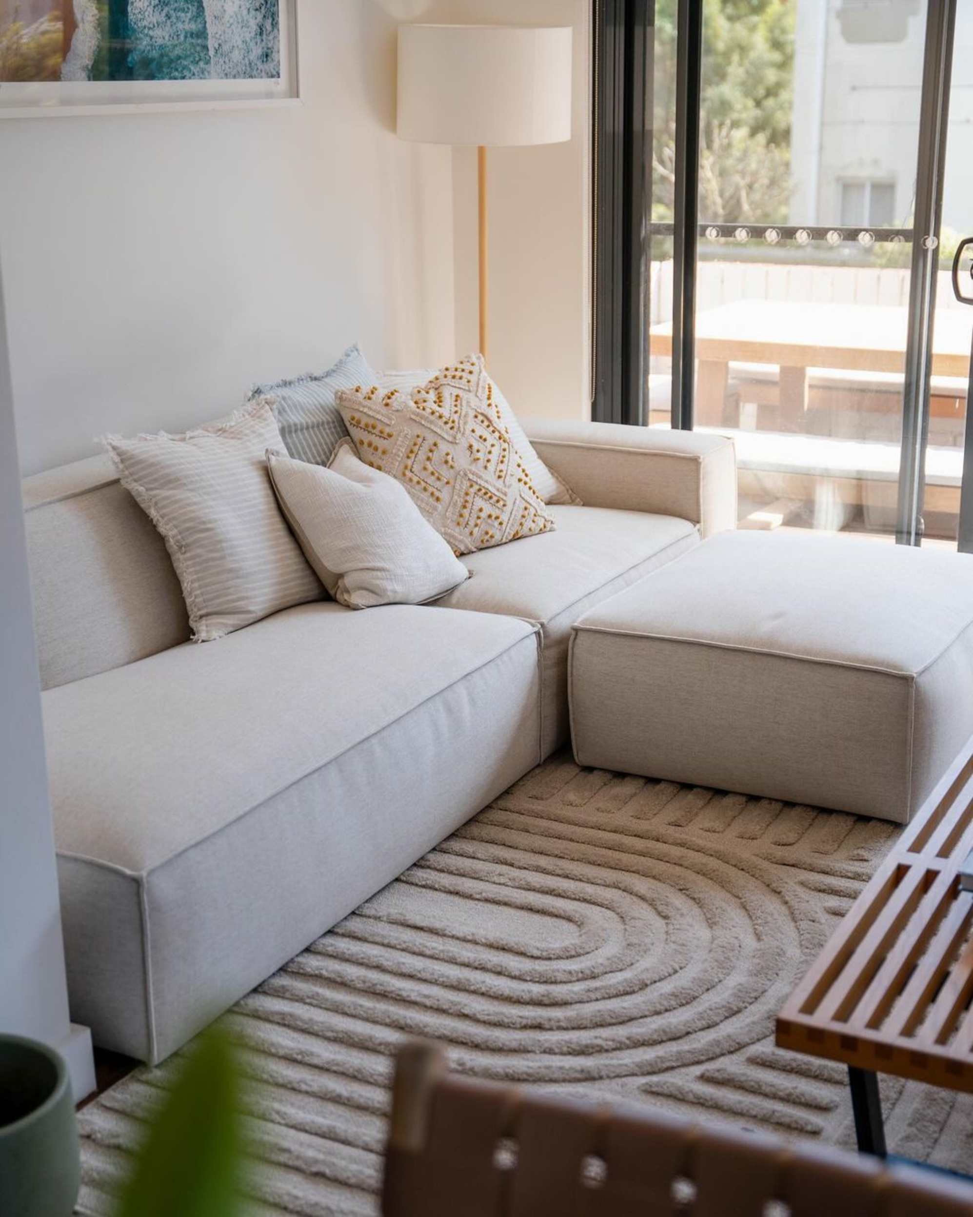 A side chaise sofa placed in the corner of a living room.