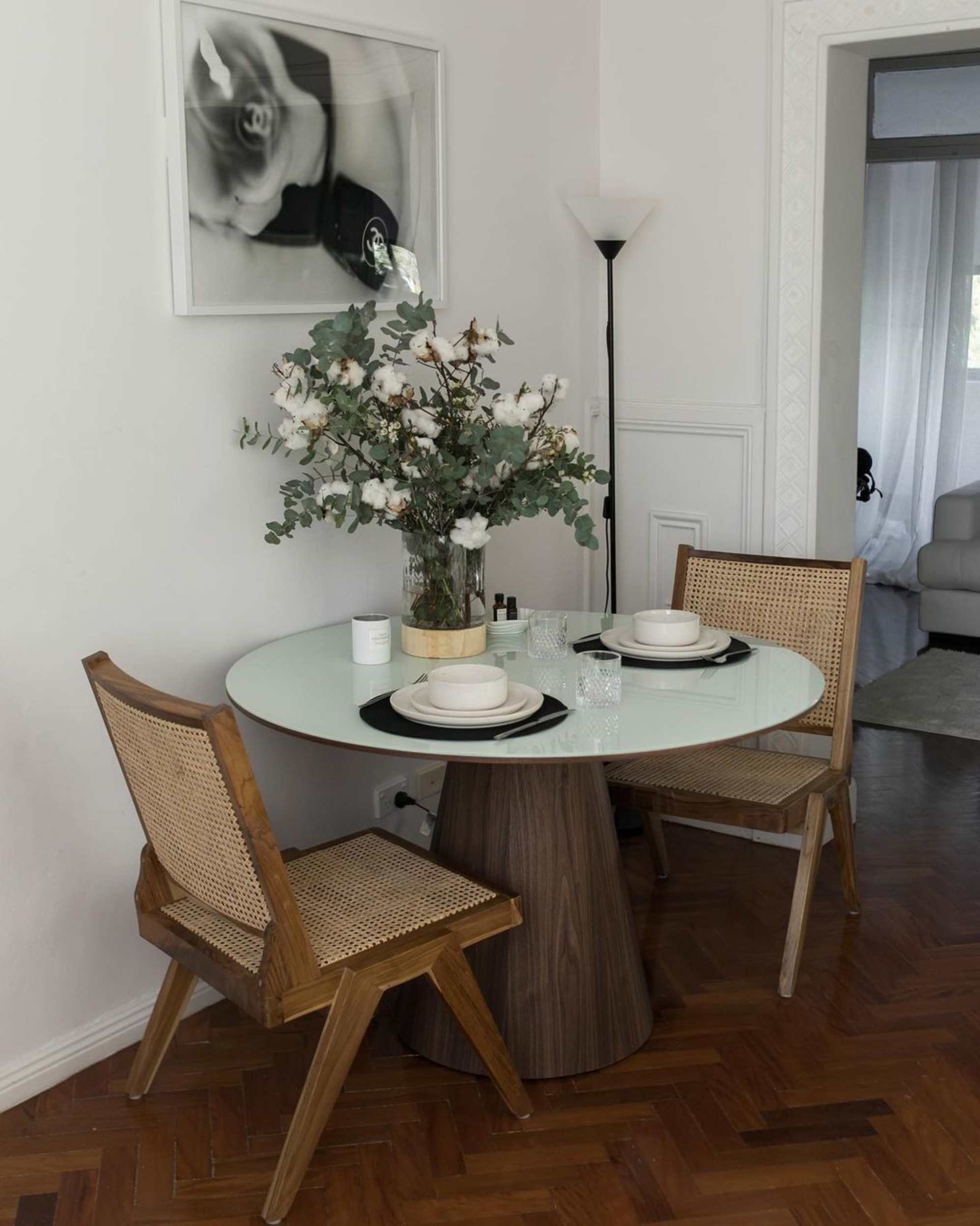 A round dining table with a glass table top.