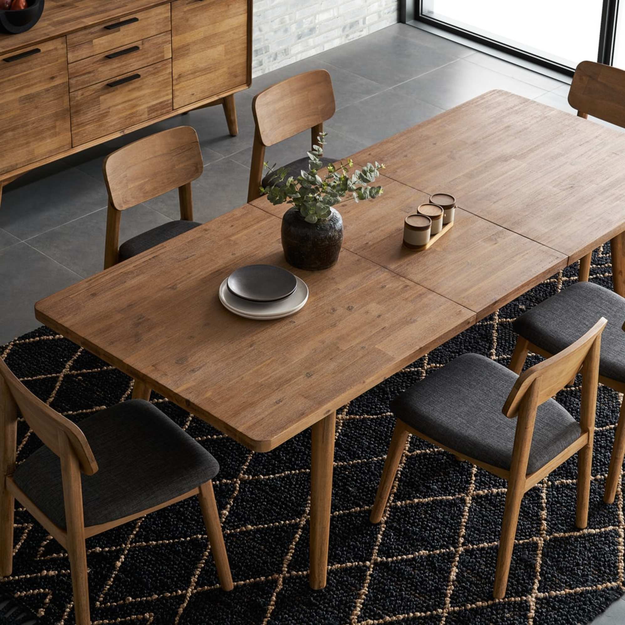 A solid acacia wood extendable dining tabel with matching dining chairs.
