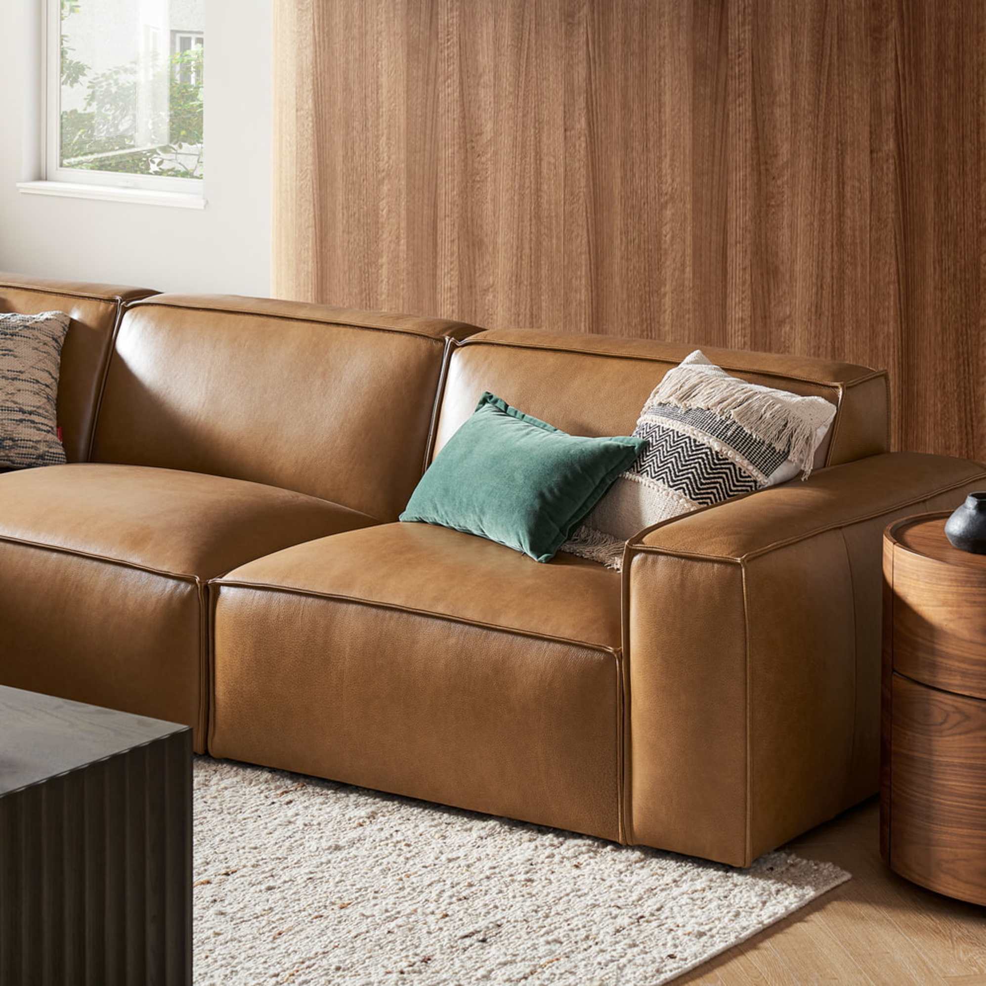 A leather extended side chaise sectional sofa in a living room.