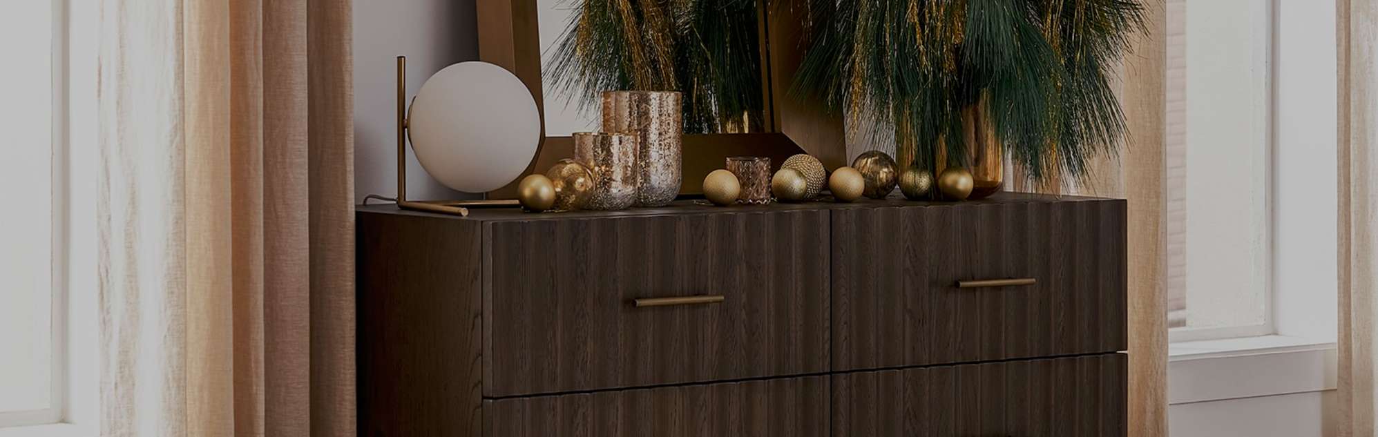 Sloane 6-Drawer Dresser, featuring subtle brass handles and classic fluted panels, embellished with Christmas decorations.