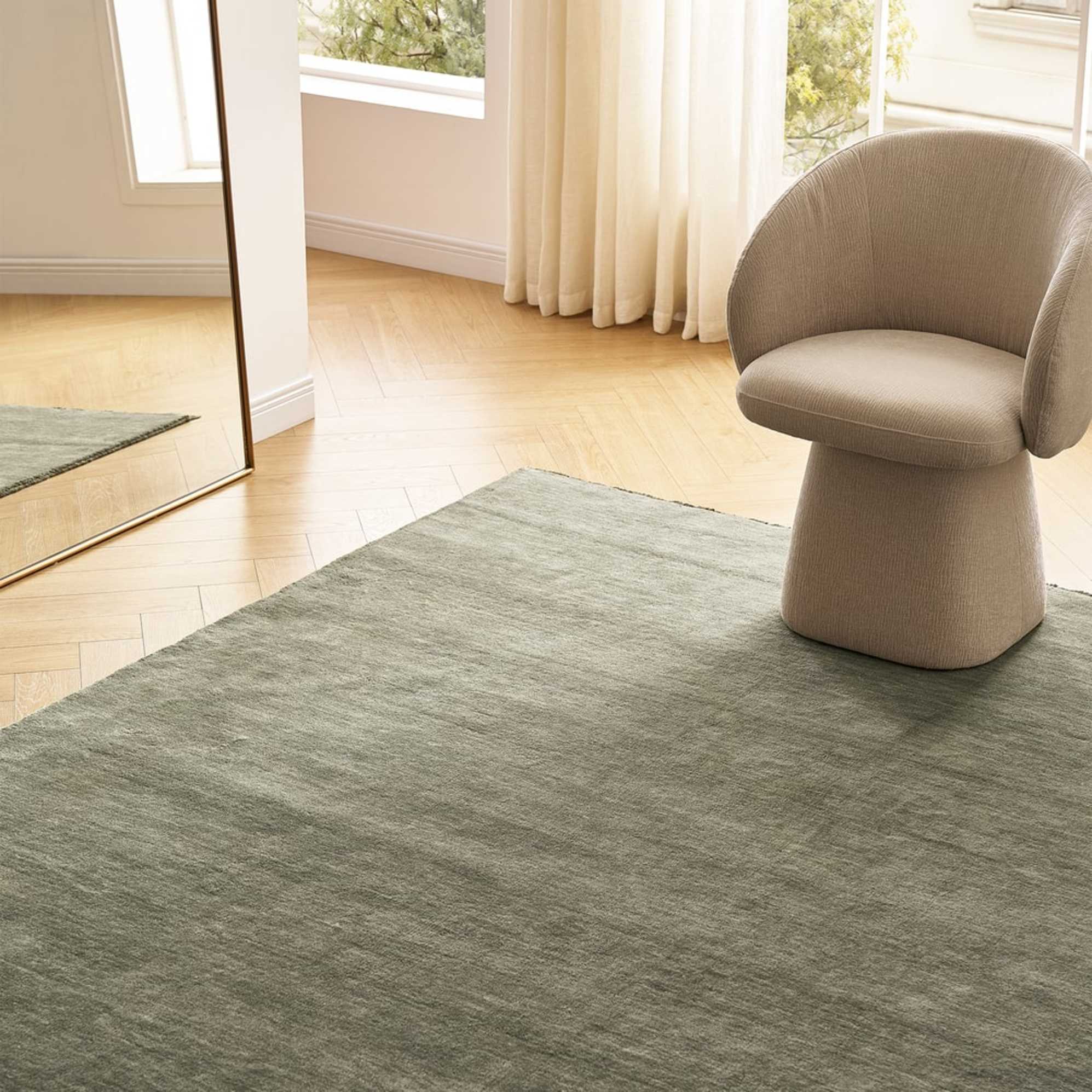 A wool area rug with a swivel armchair placed on it. 