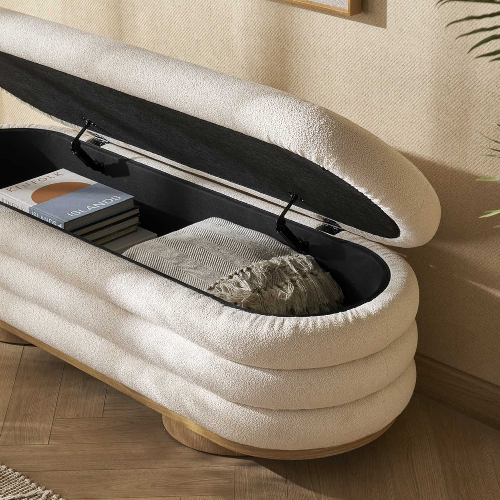 A performance fabric storage bench with its seat lifted up to reveal concealed storage space.