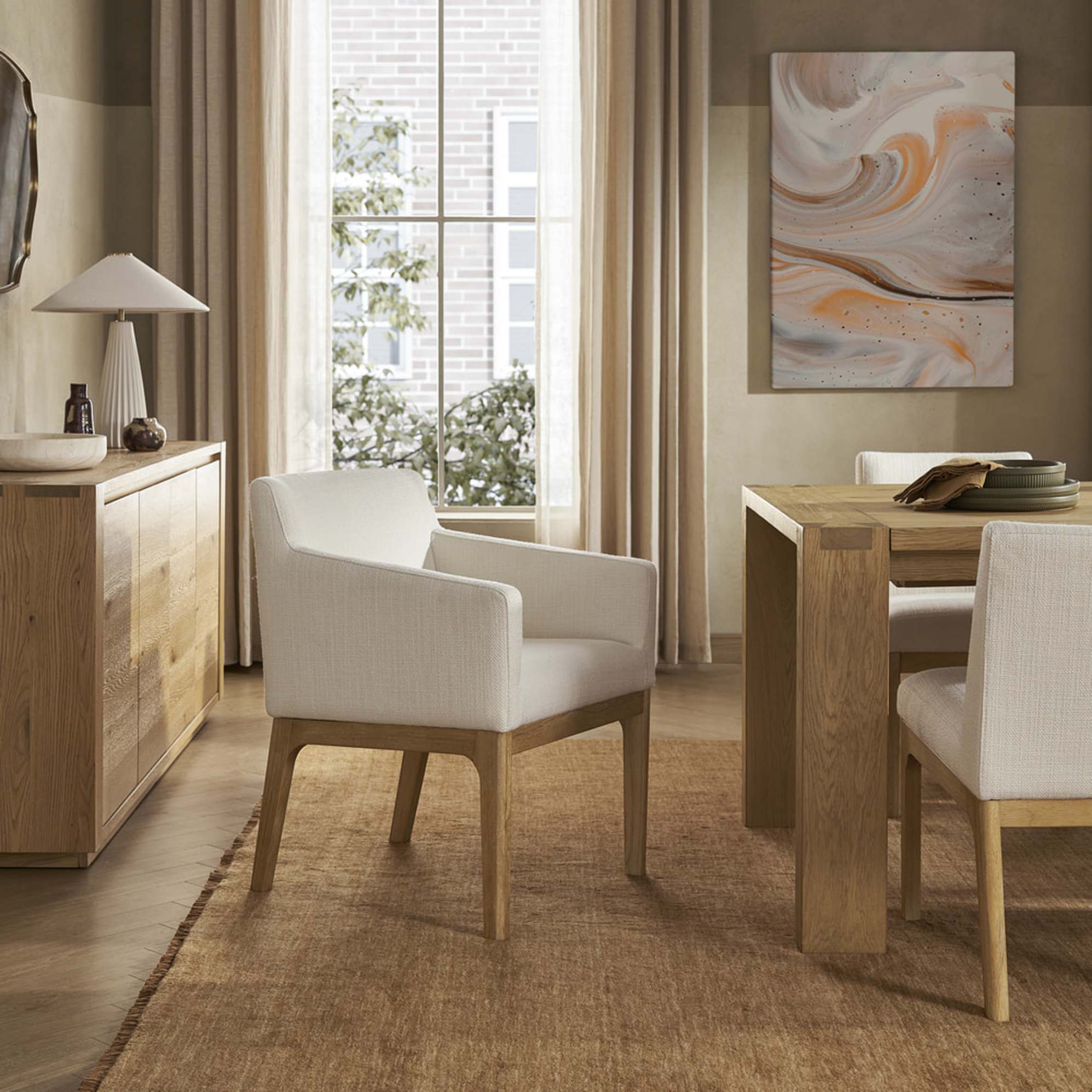 A performance fabric armchair with a wooden base and legs.