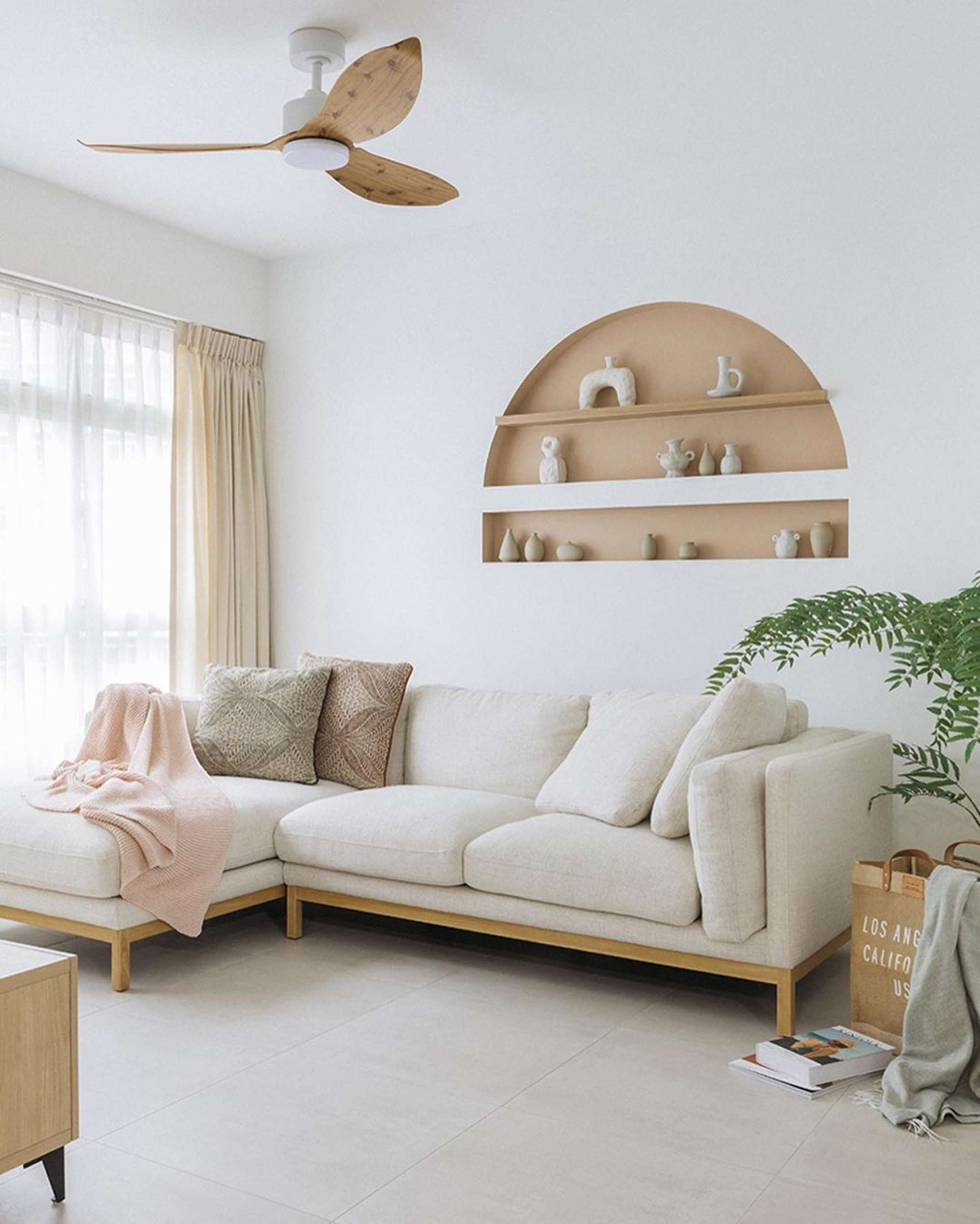 A chaise sectional sofa placed against a wall with a built-in alcove.