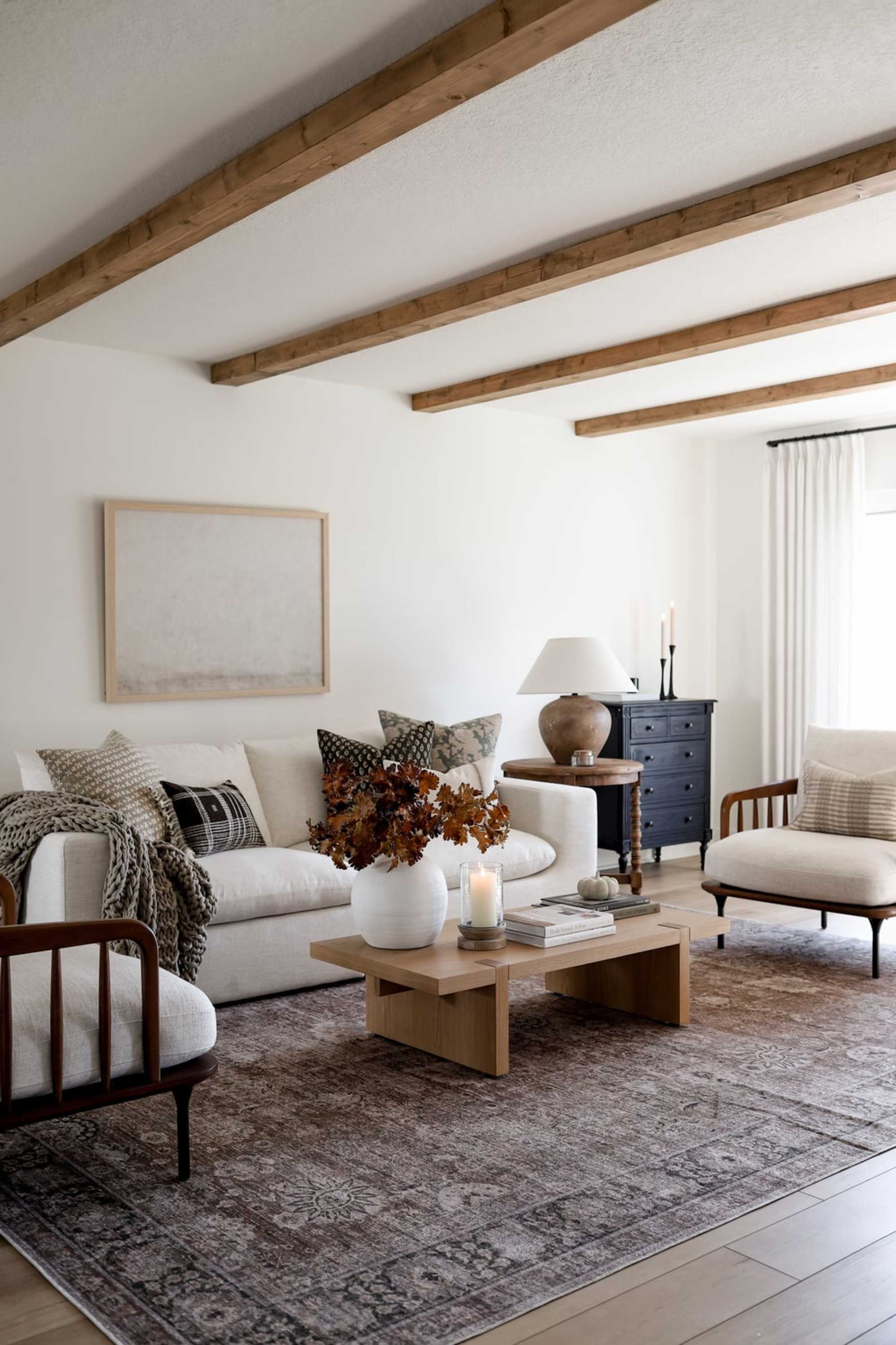 A sofa, two matching armchairs, and a wooden rectangular coffee table.