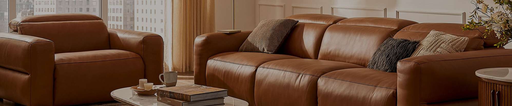 A leather recliner sofa and armchair in a living room.