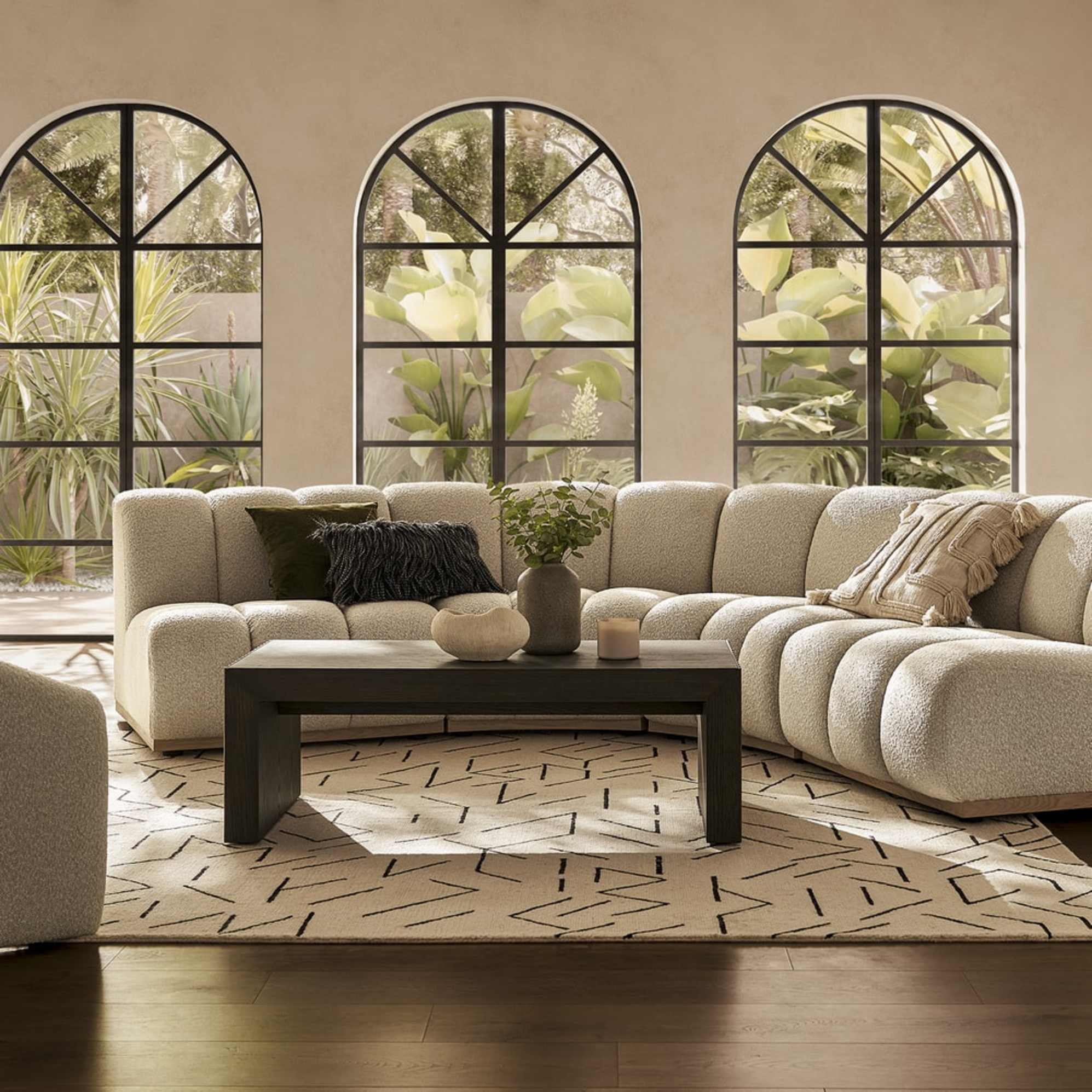 A performance fabric sofa placed in a living room with throw cushions.