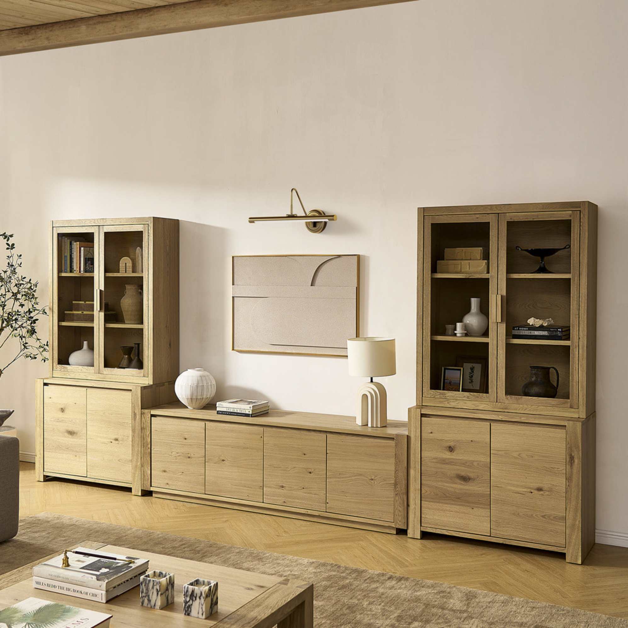 A wooden media console system with glass cabinets.