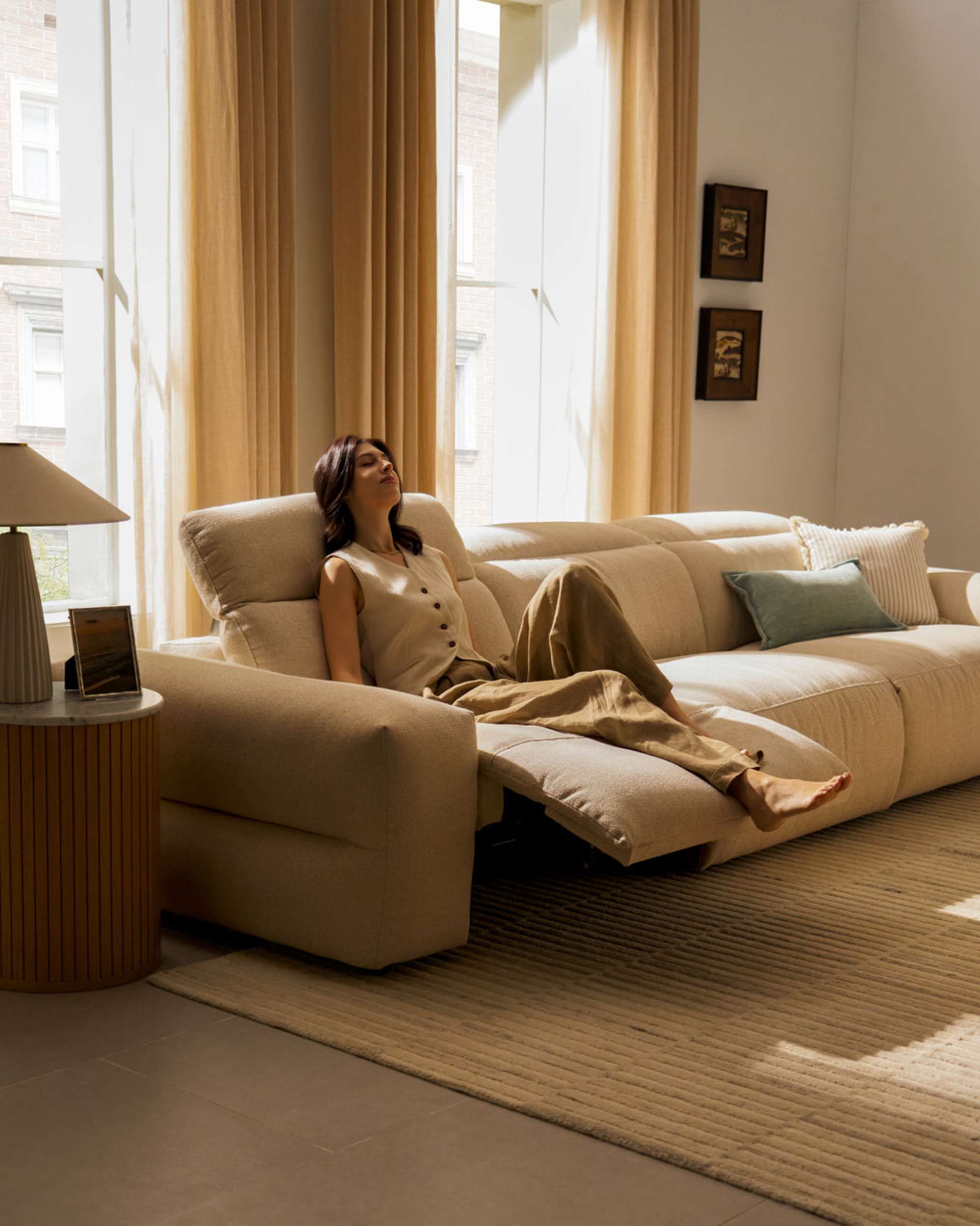 A person sitting on a recliner sofa module.