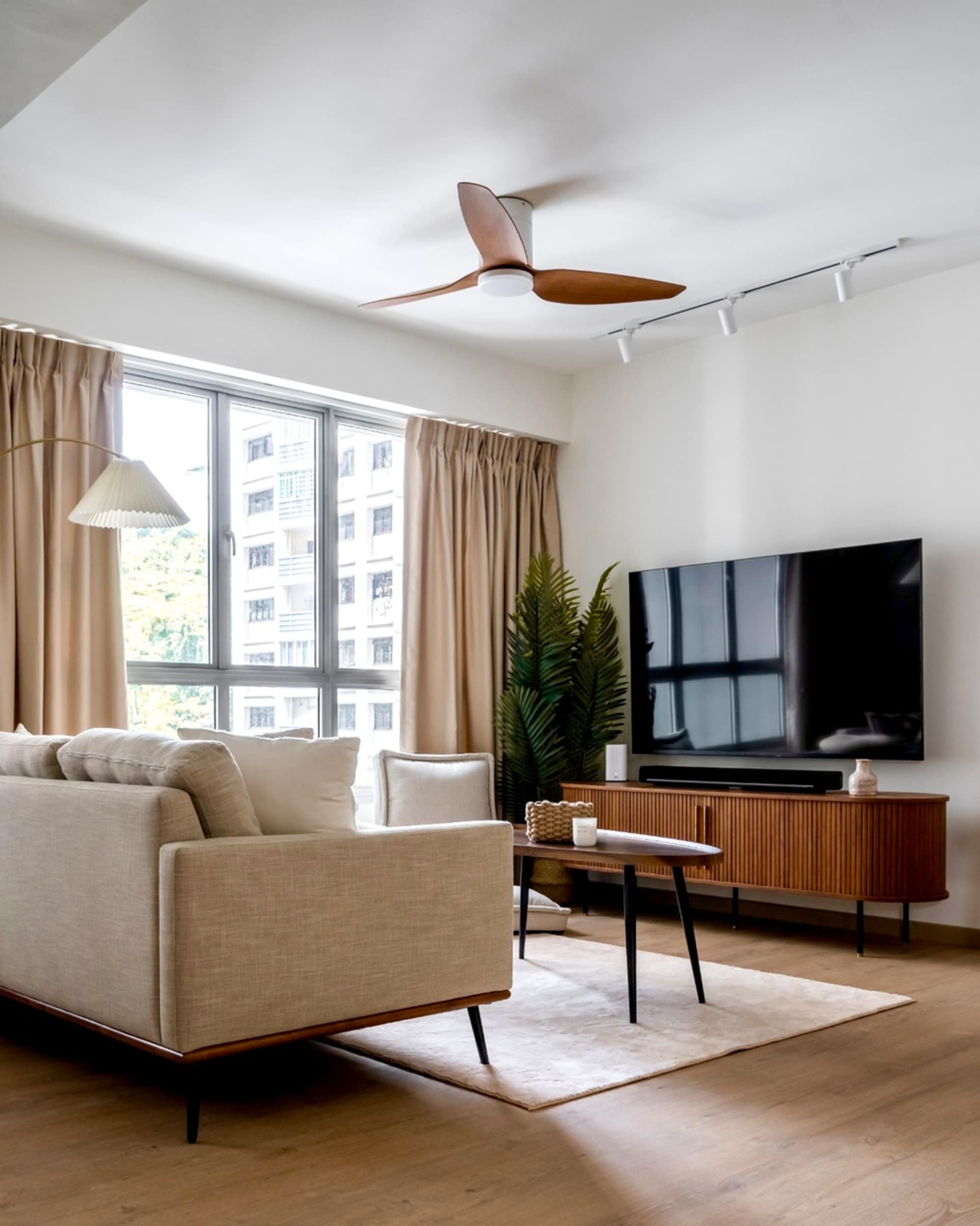A 3-seater sofa with a wall-mounted TV.