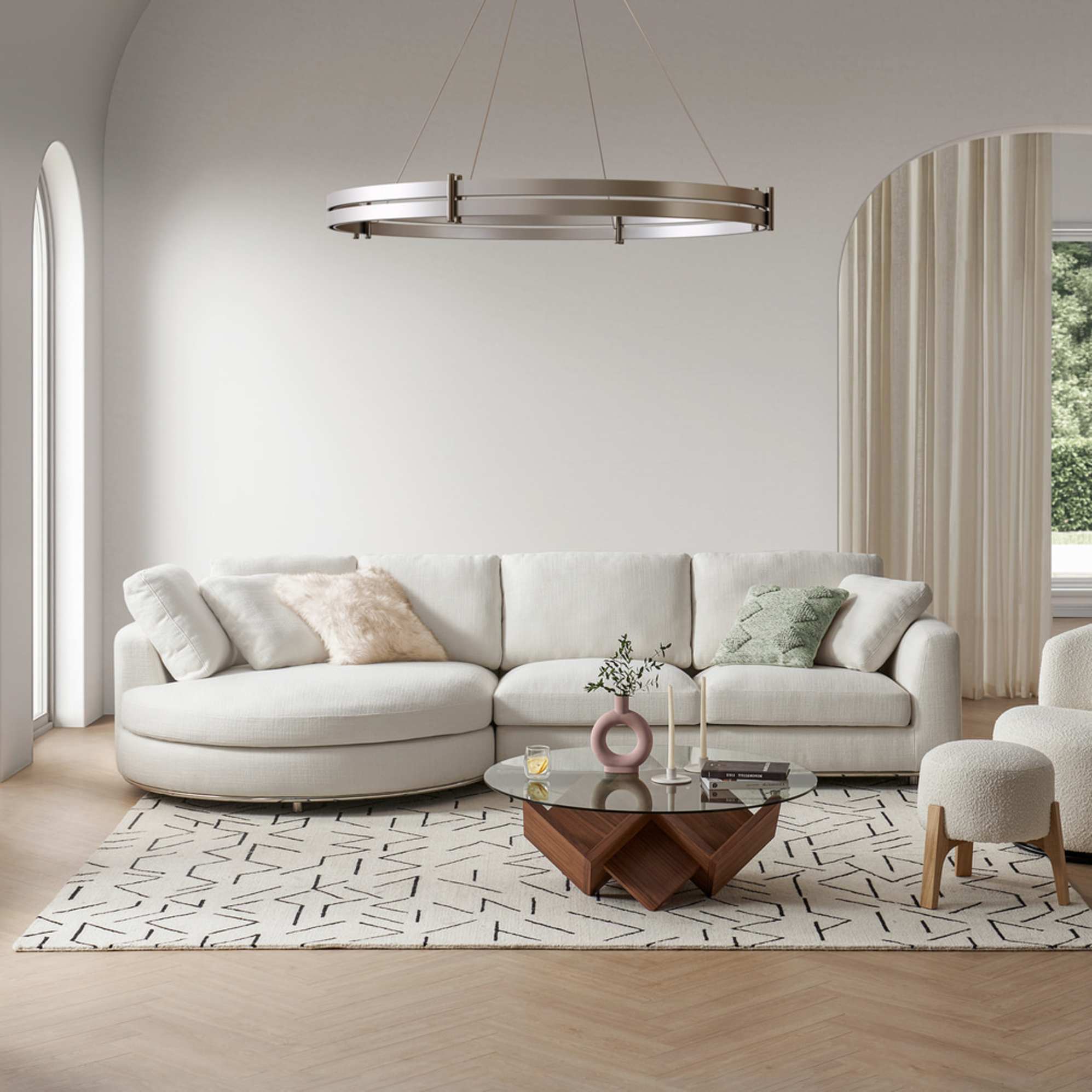 A round chaise sectional sofa with a sculptural coffee table in a living room.