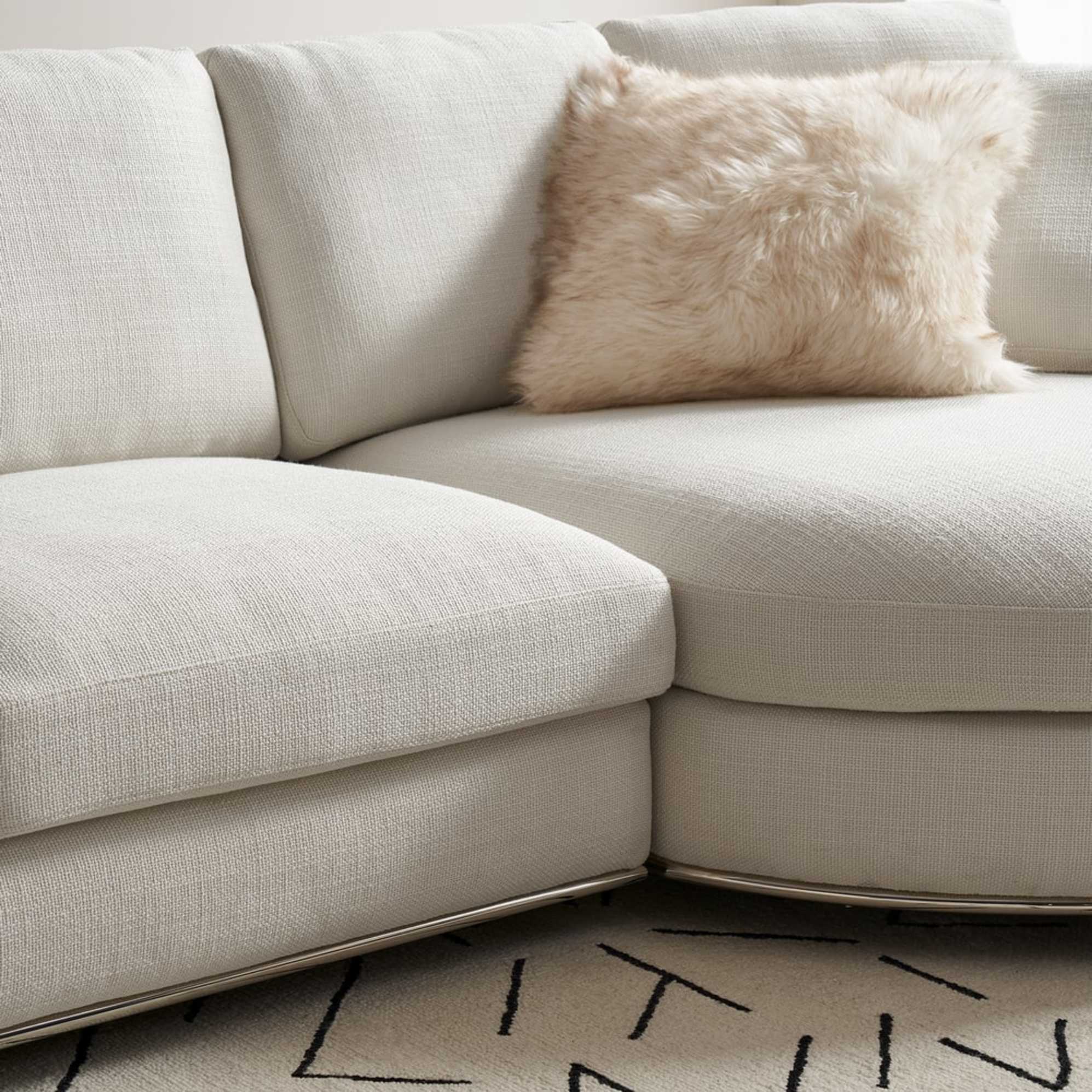 A close-up shot of a sofa with a round chaise module.