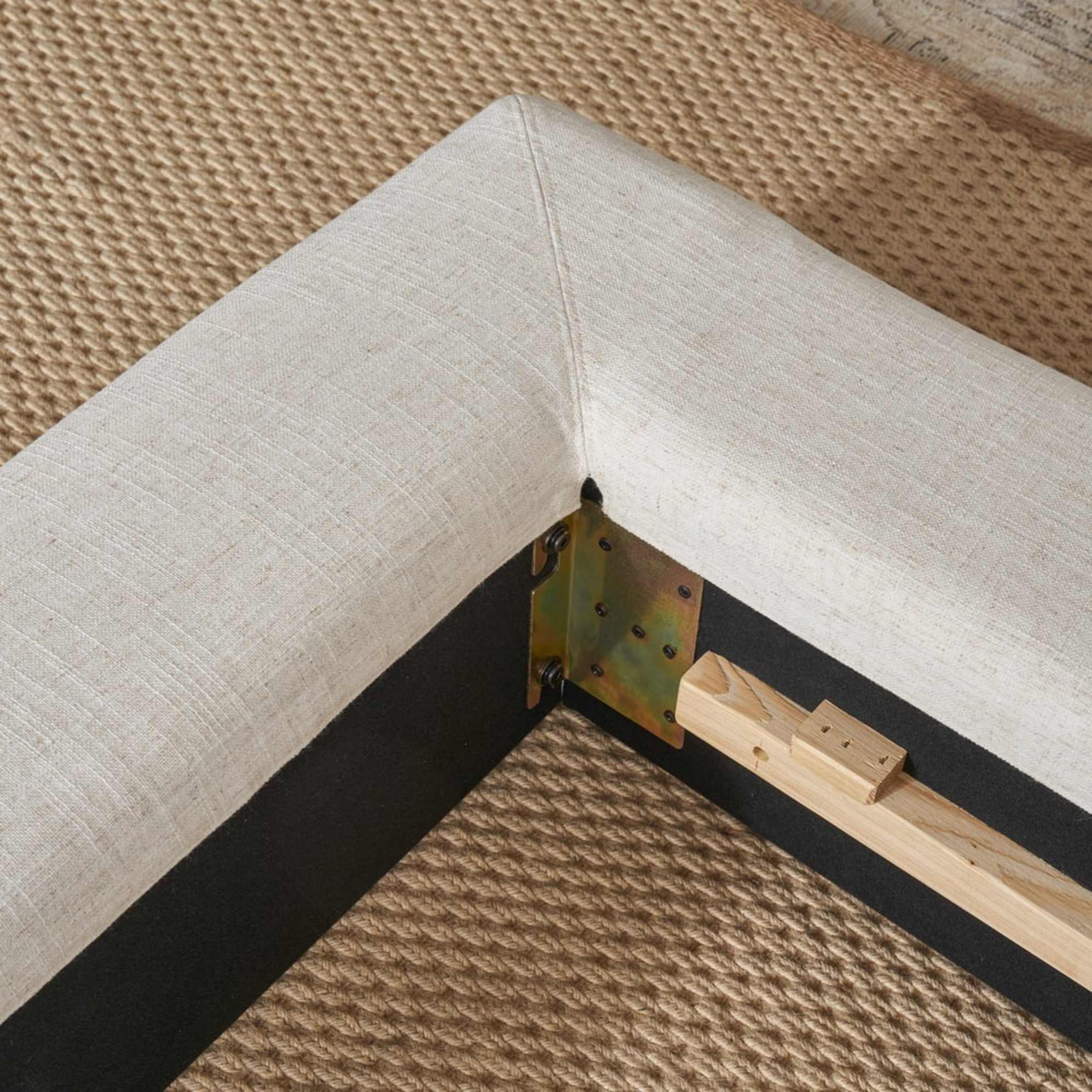 A close-up shot of the corner of a bed.