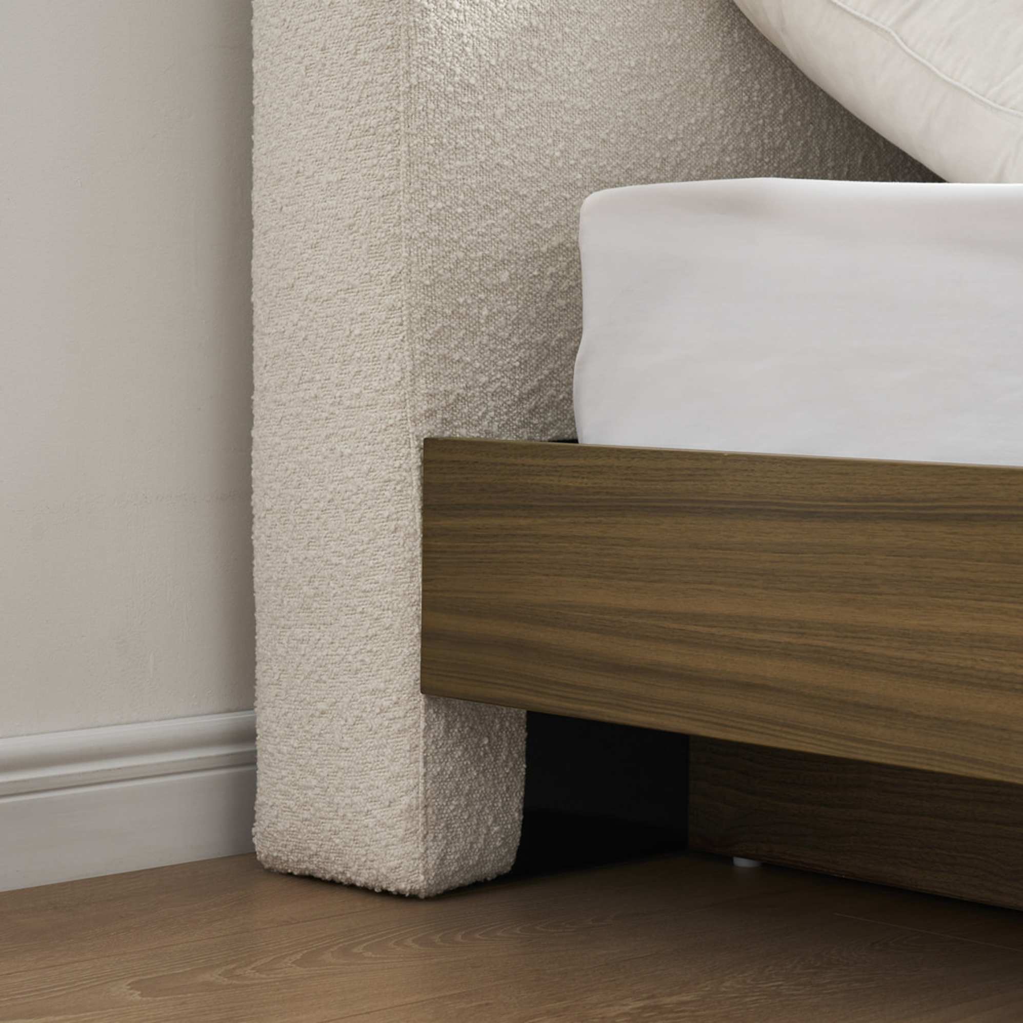 A close-up shot of a bouclé bed's legs.