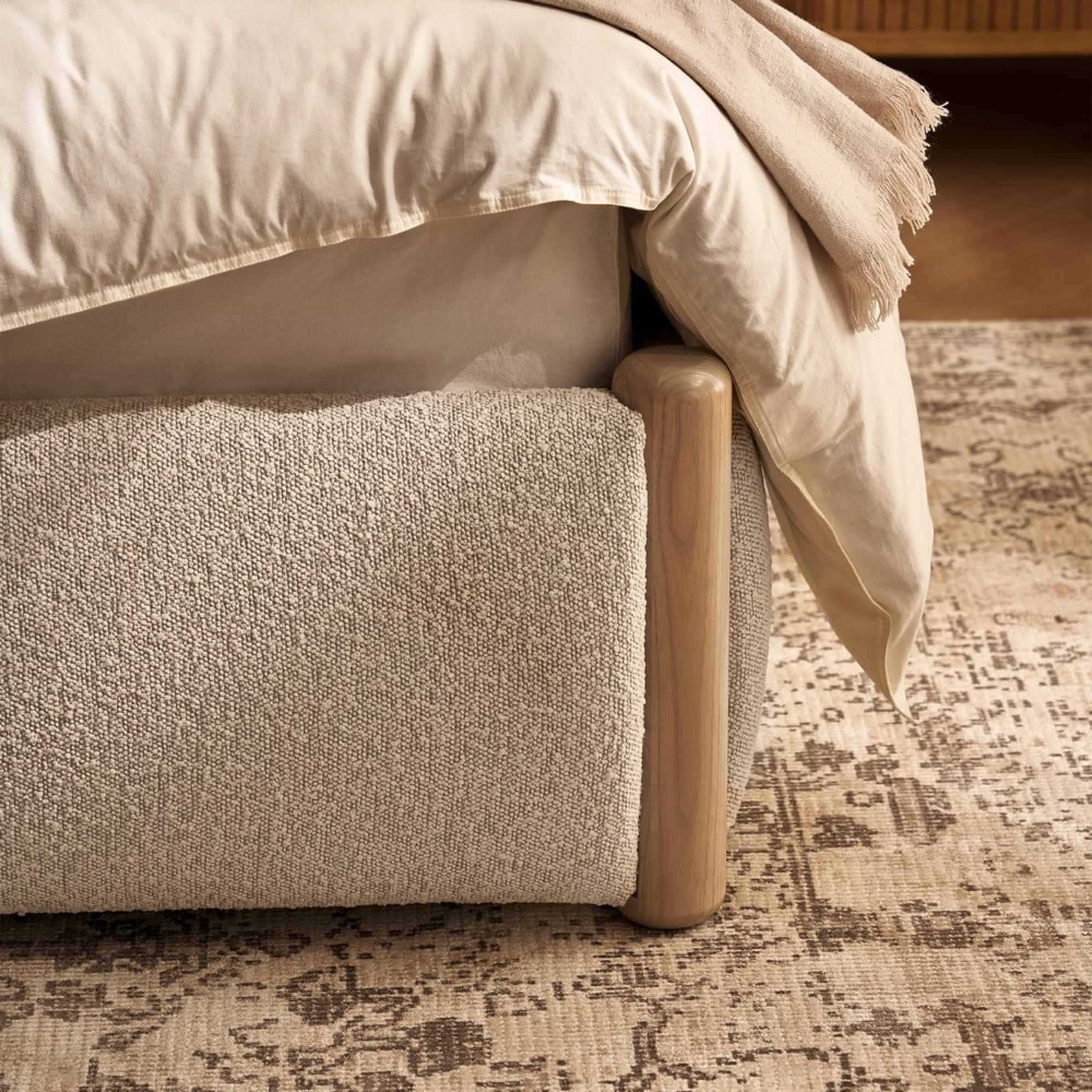 The wooden posts of a performance fabric bed.