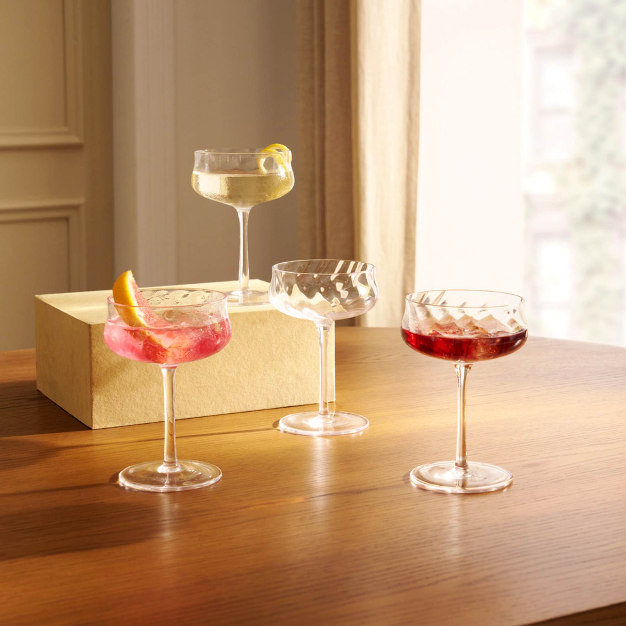 A set of four couple glasses placed on a dining table.