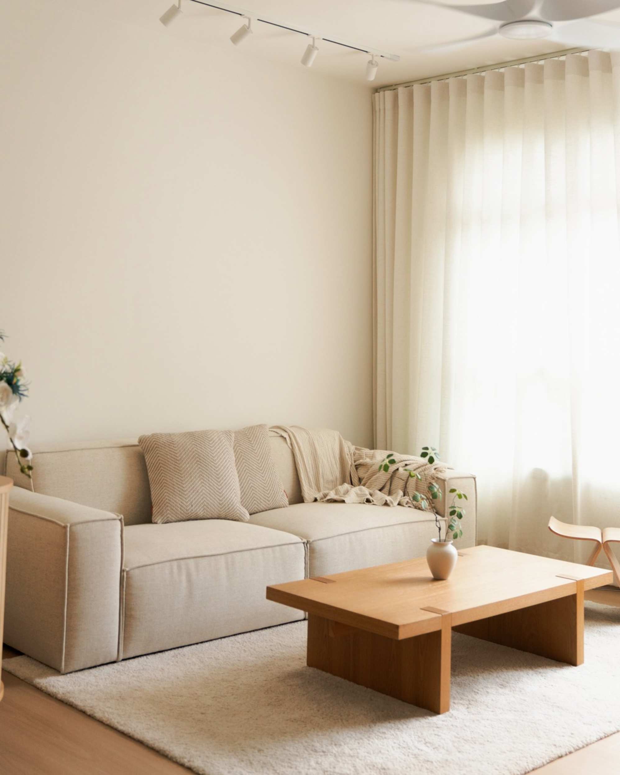 A white sofa with a brown coffee table.