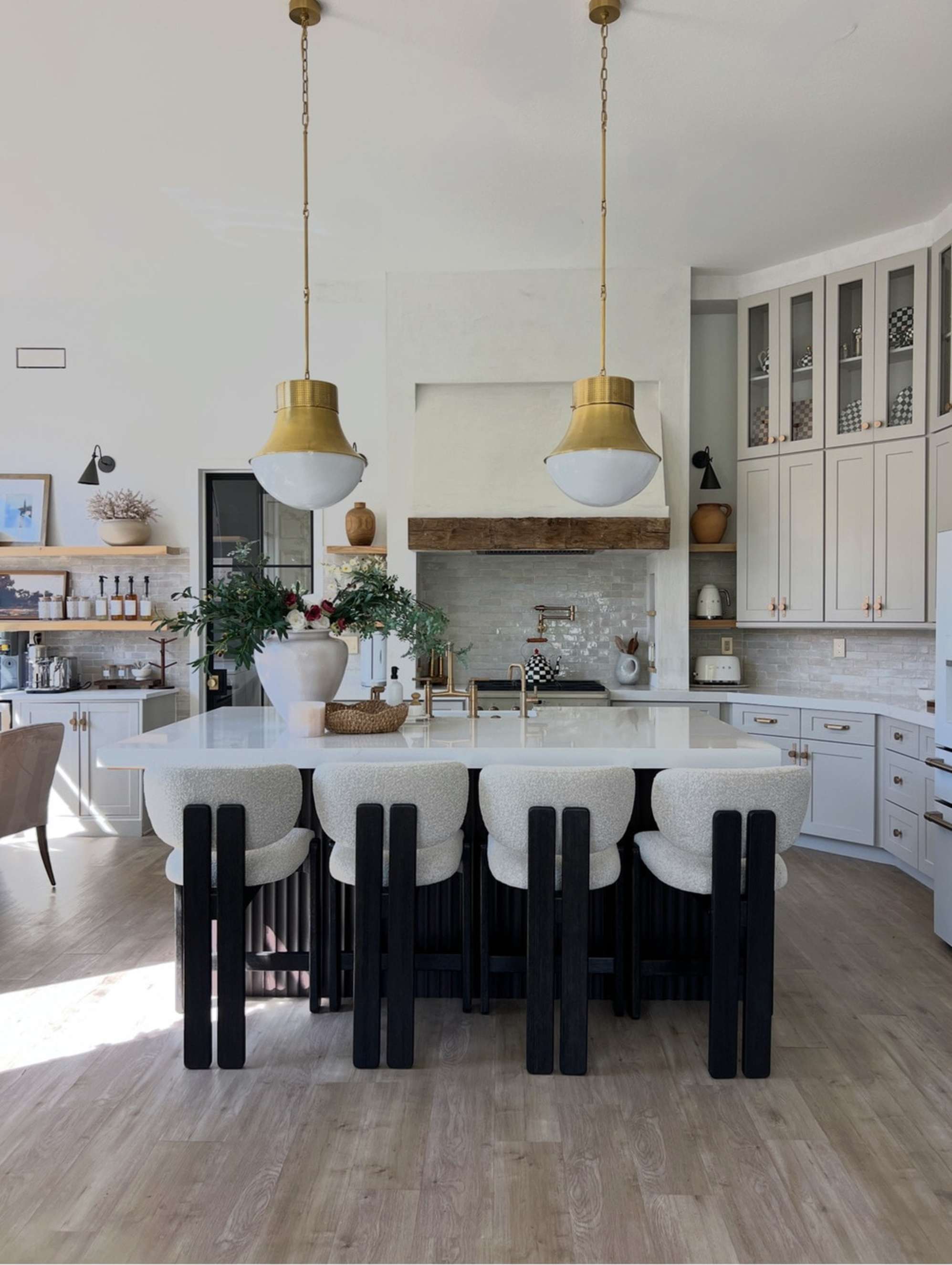 Four counter stools placed at a marble kitchen island.