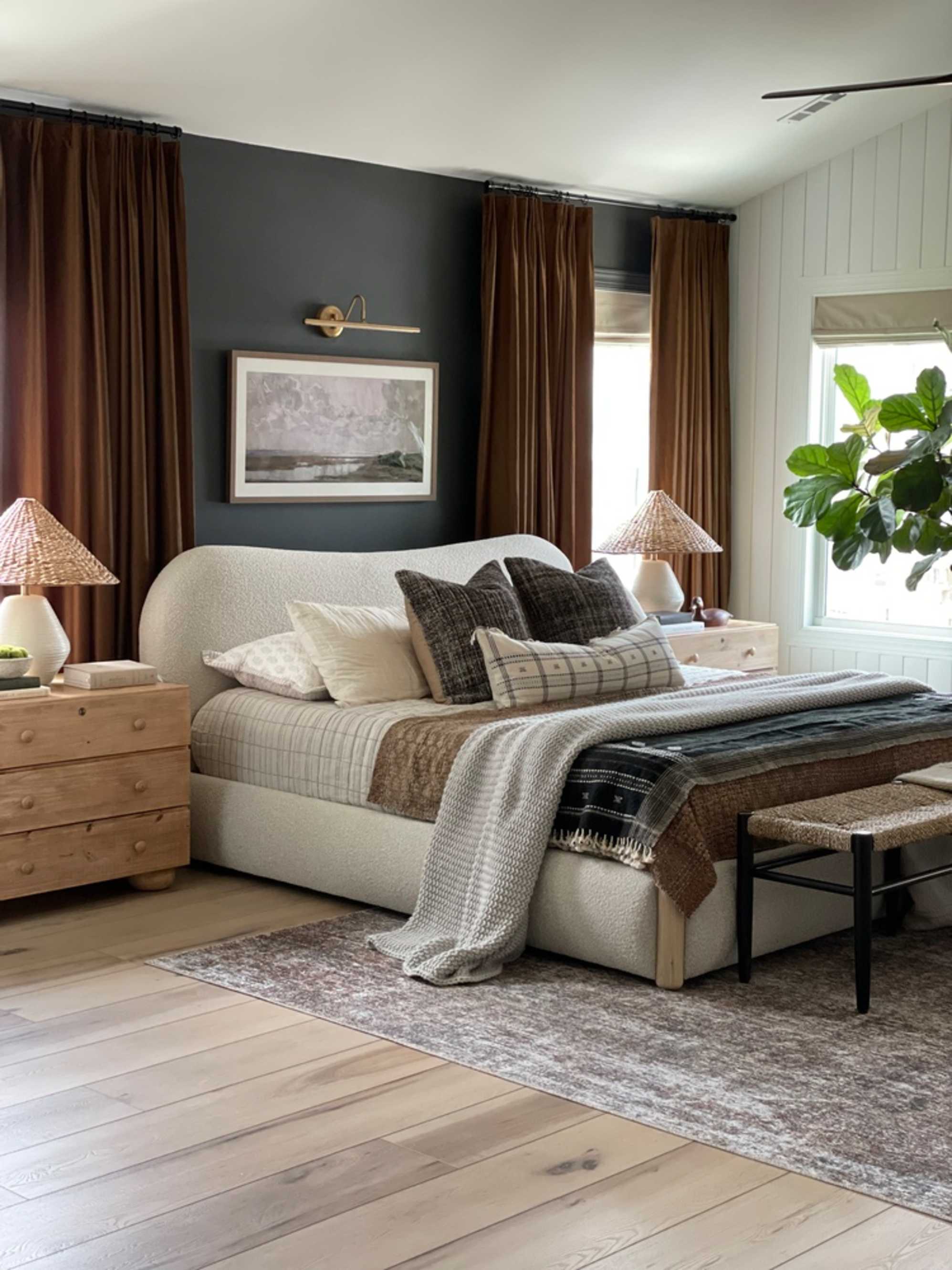 A performance fabric curved headboard placed in a bedroom.