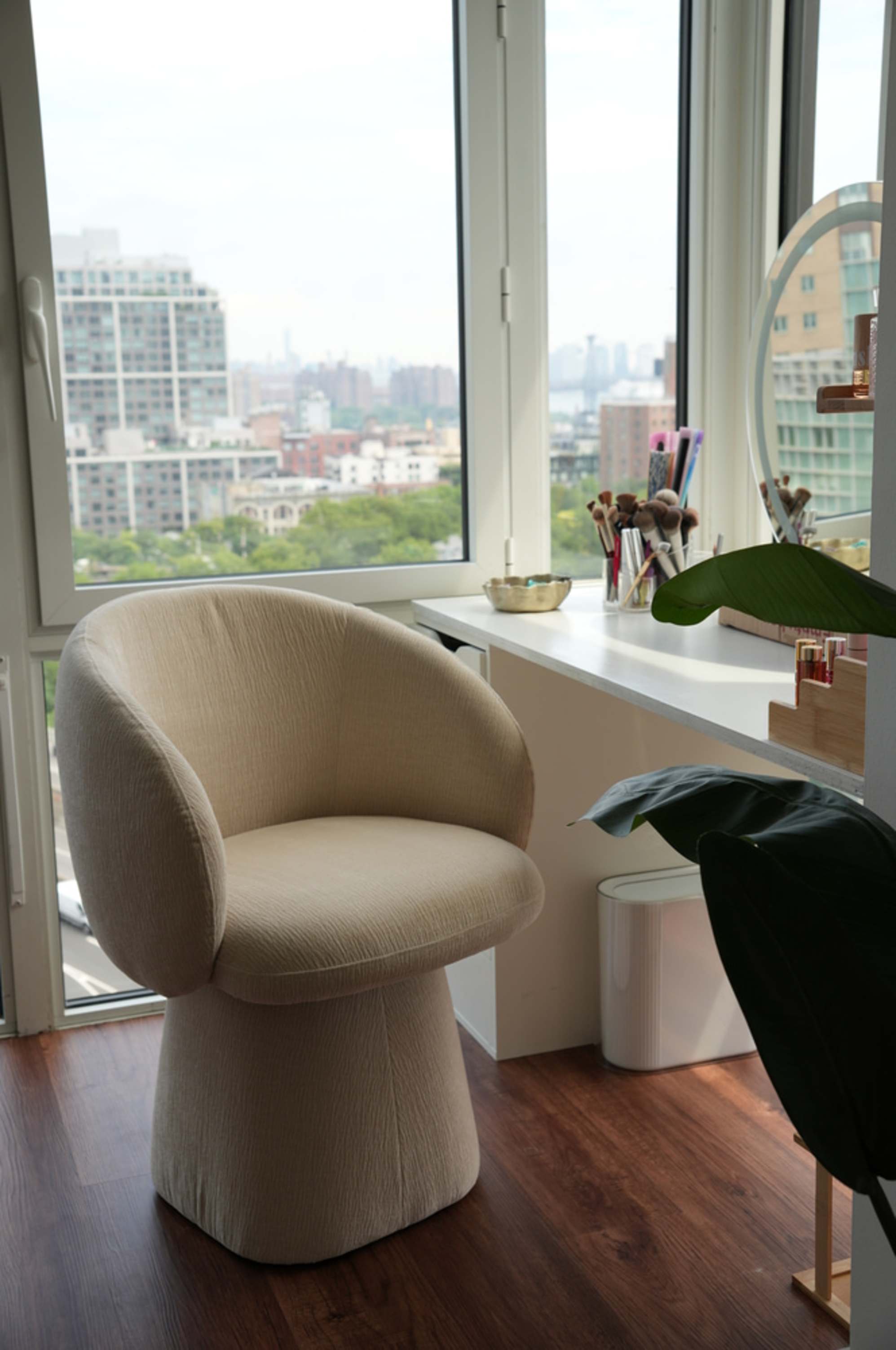 A swivel chair is placed at a desk in the corner of a room.