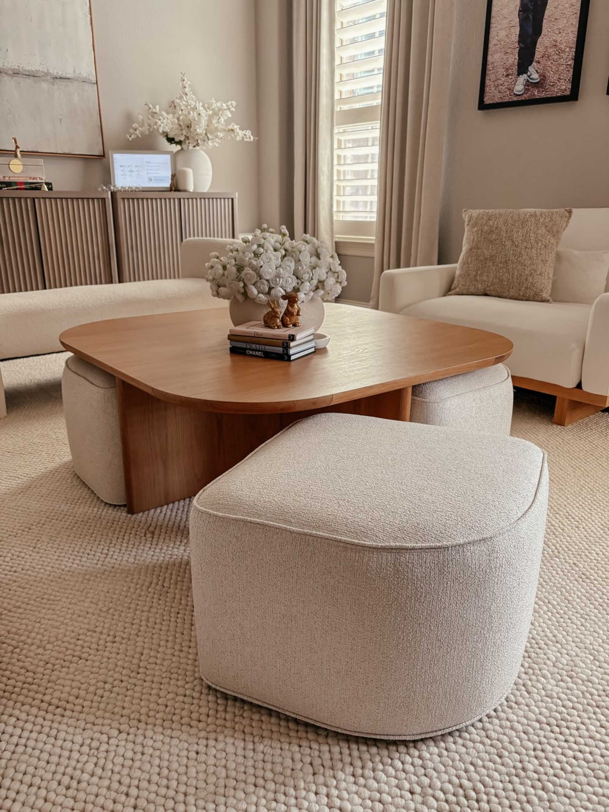 A nesting square coffee table is placed in a living room.