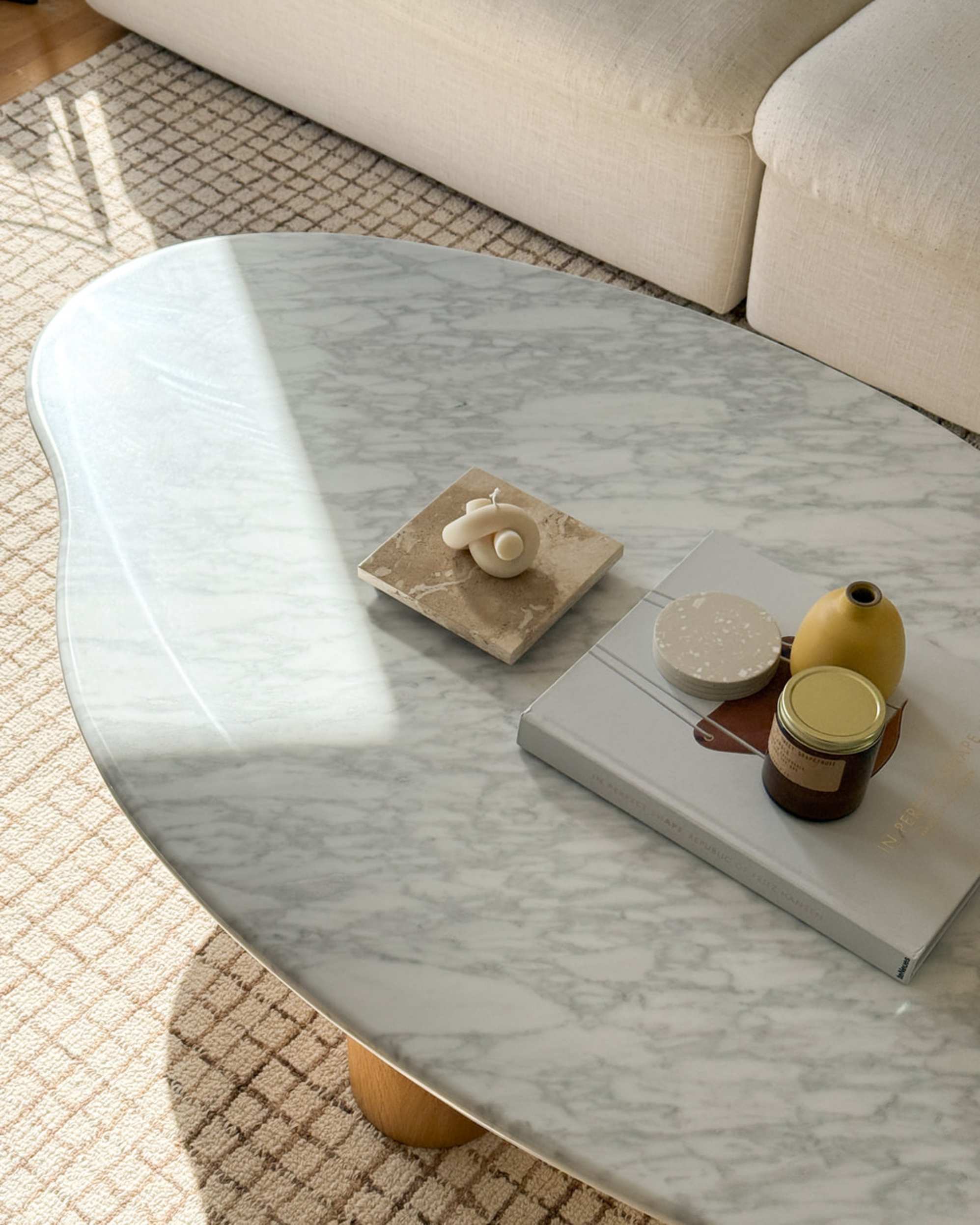 A marble coffee with decor placed in a living room.