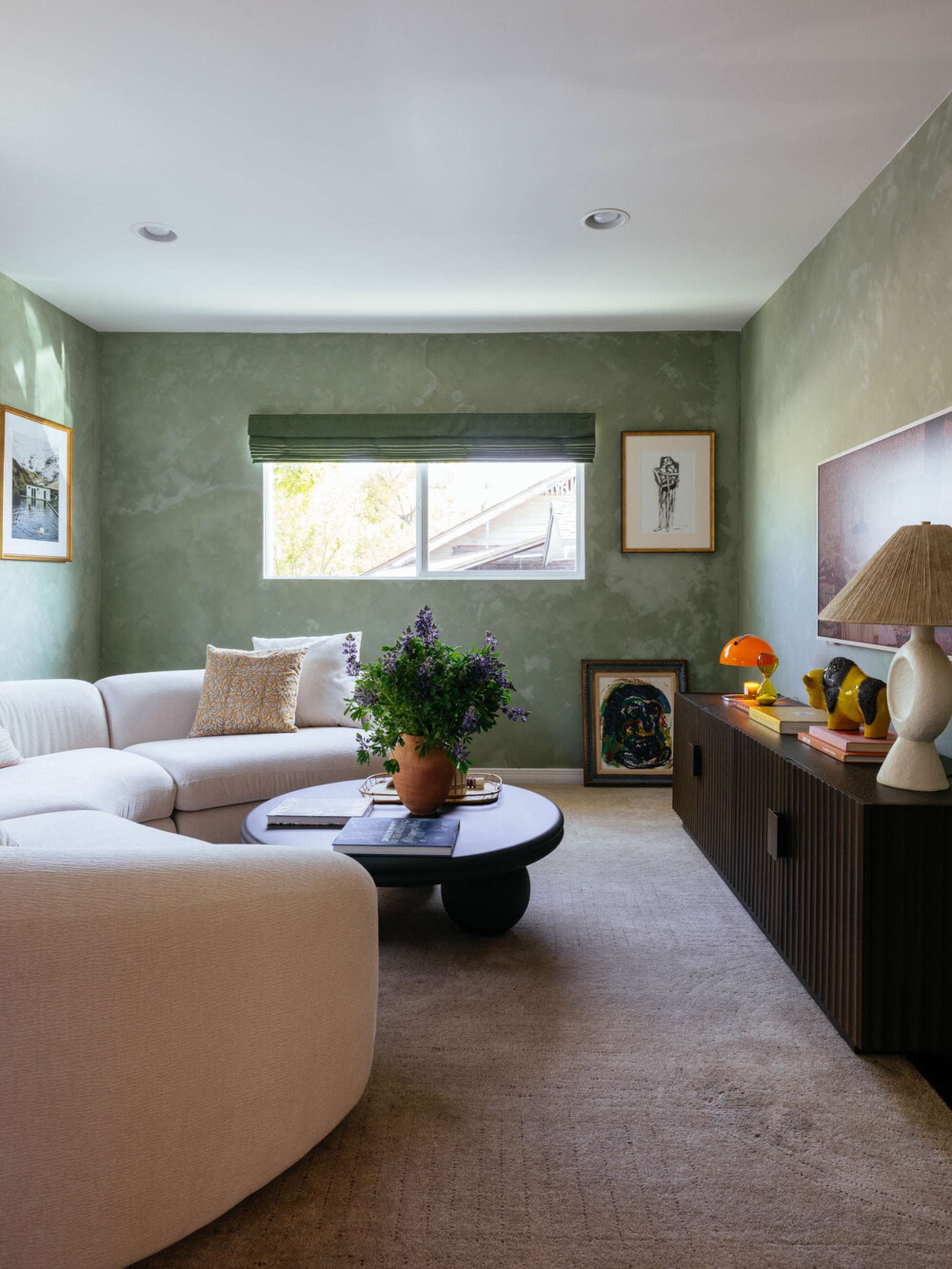 A round black coffee table and a performance fabric sectional sofa.