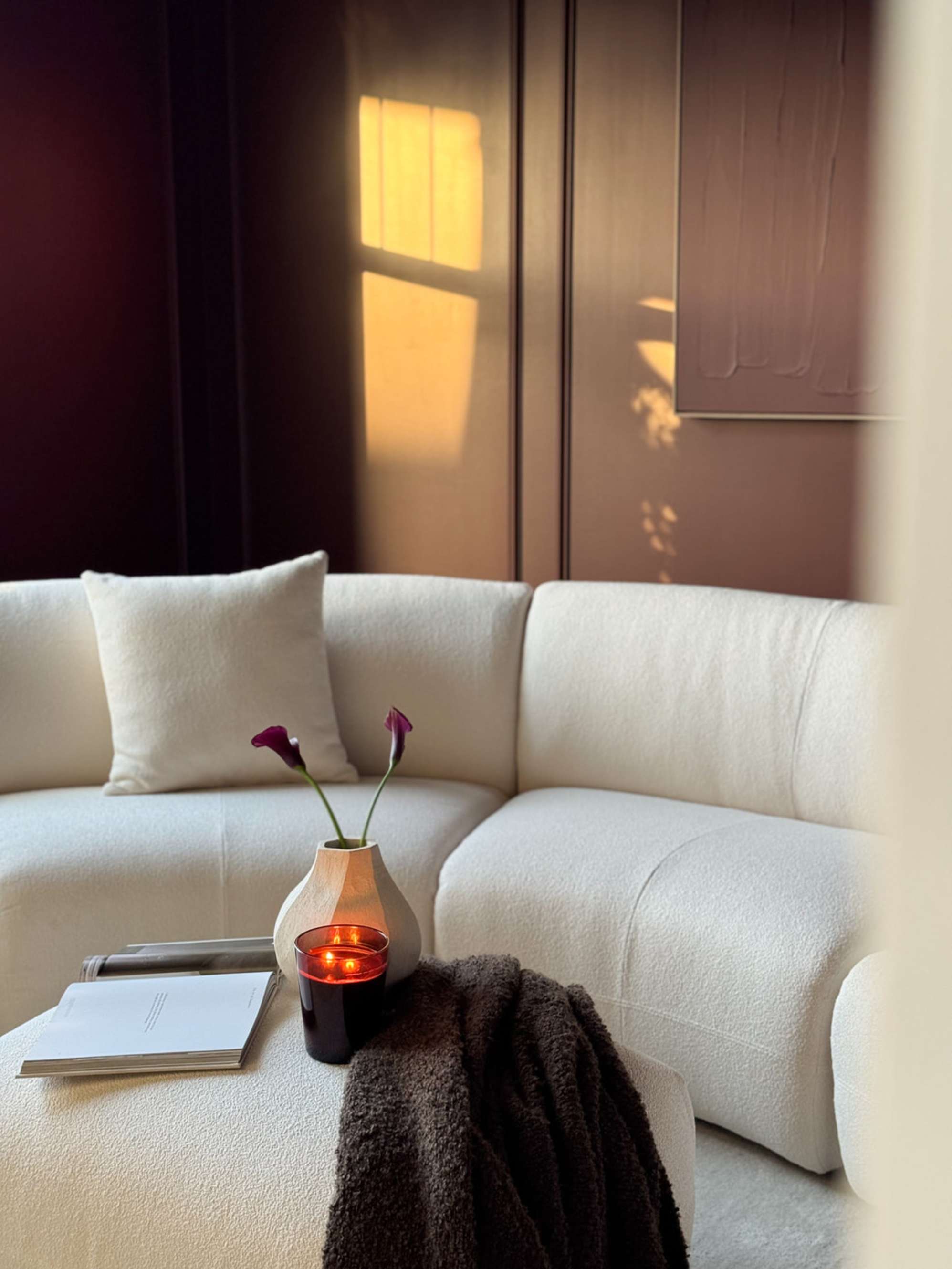 A performance fabric curve sofa with a matching ottoman.