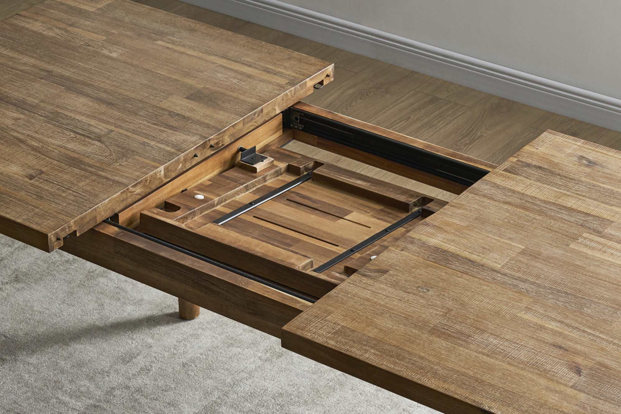 An acacia wood extendable dining table. 