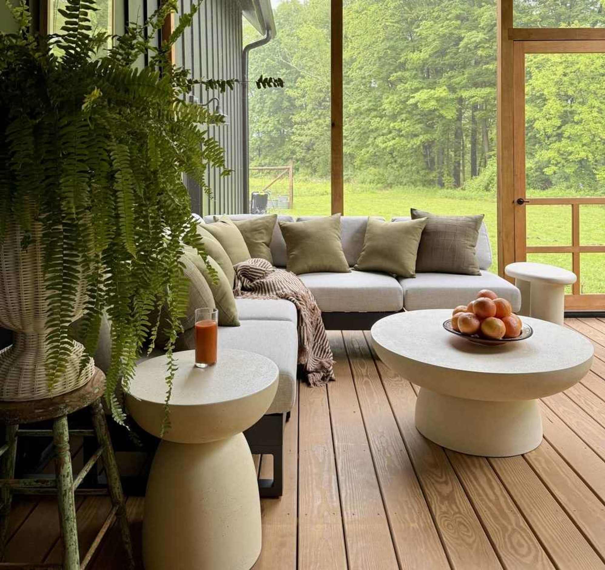 A matching side table and coffee table set placed with an aluminum sectional sofa.