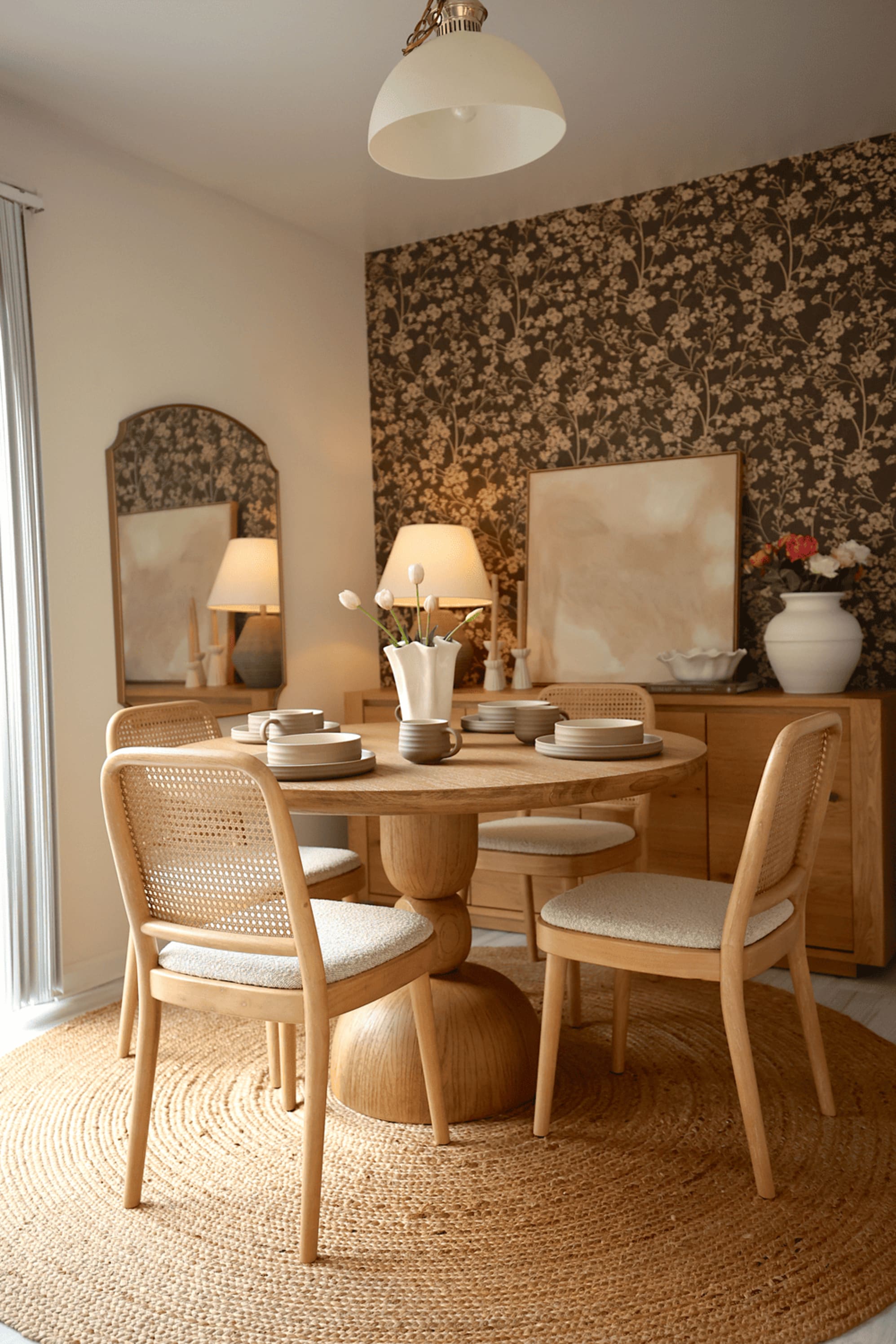 A wooden dining table with cane dining chairs.