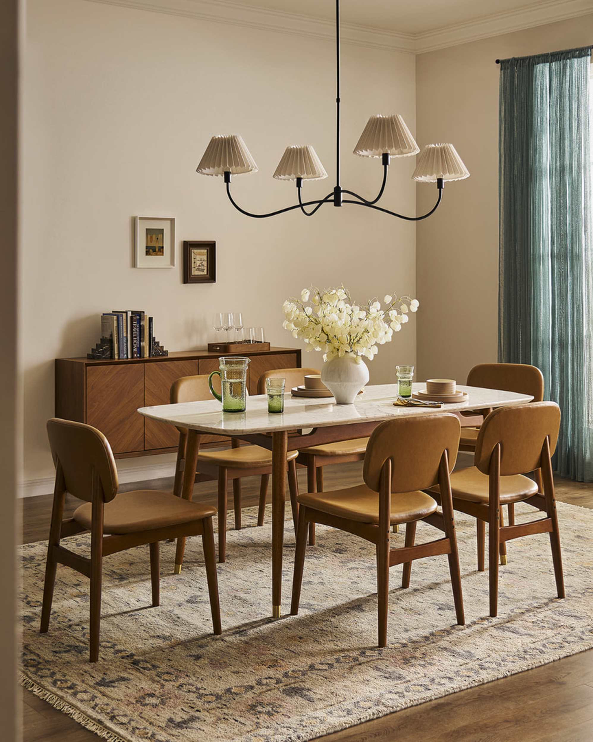 A marble dining table with leather chairs.