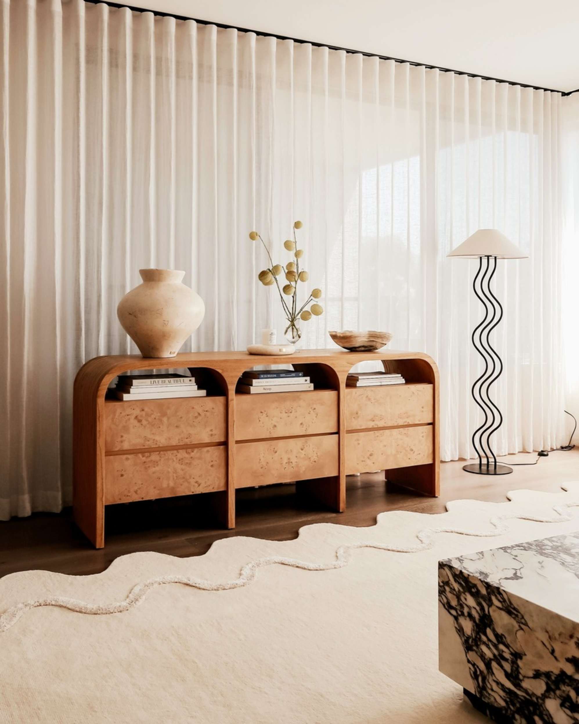 A wooden 6-drawer dresser placed in a living room.