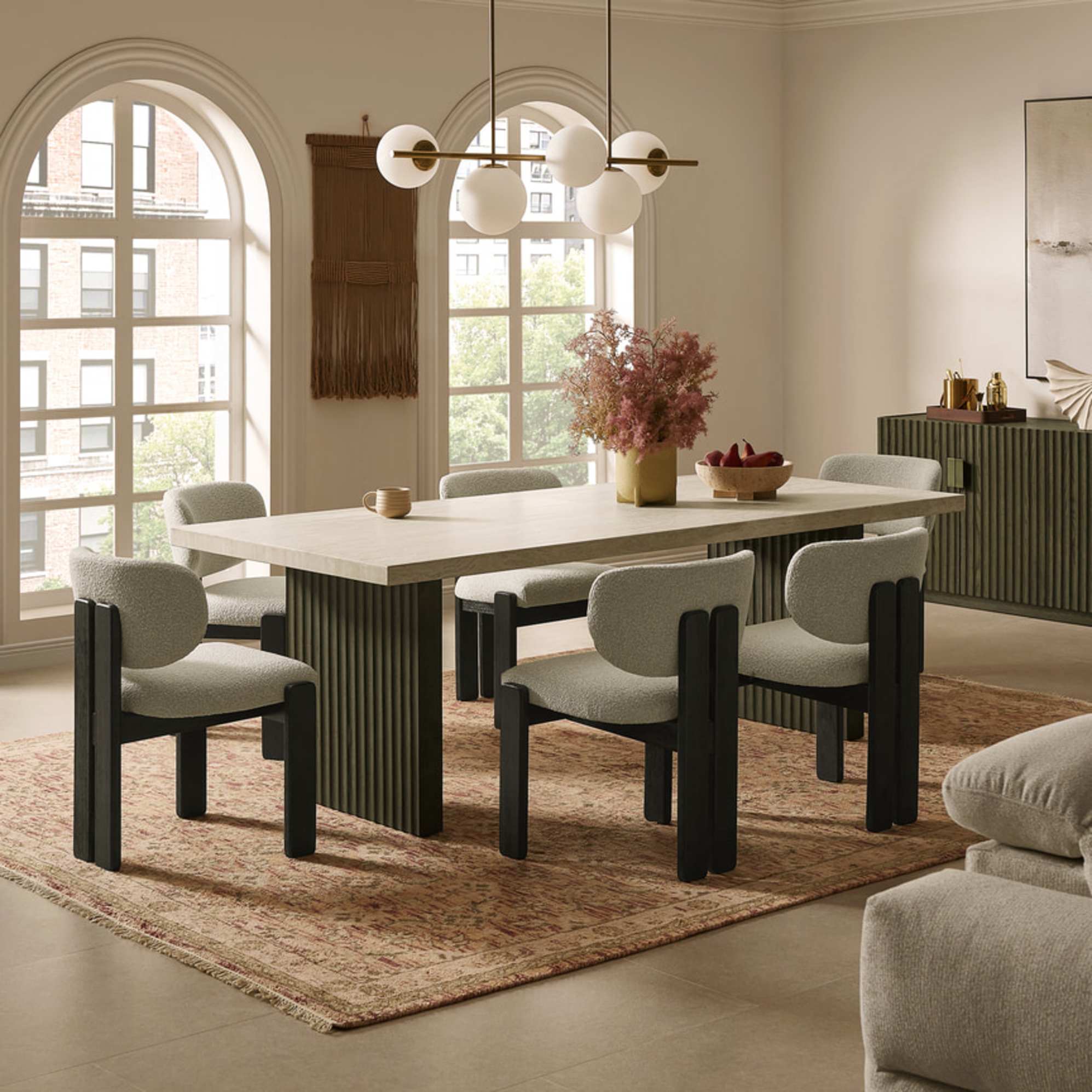 A dining table with a travertine tabletop and six matching dining chairs.