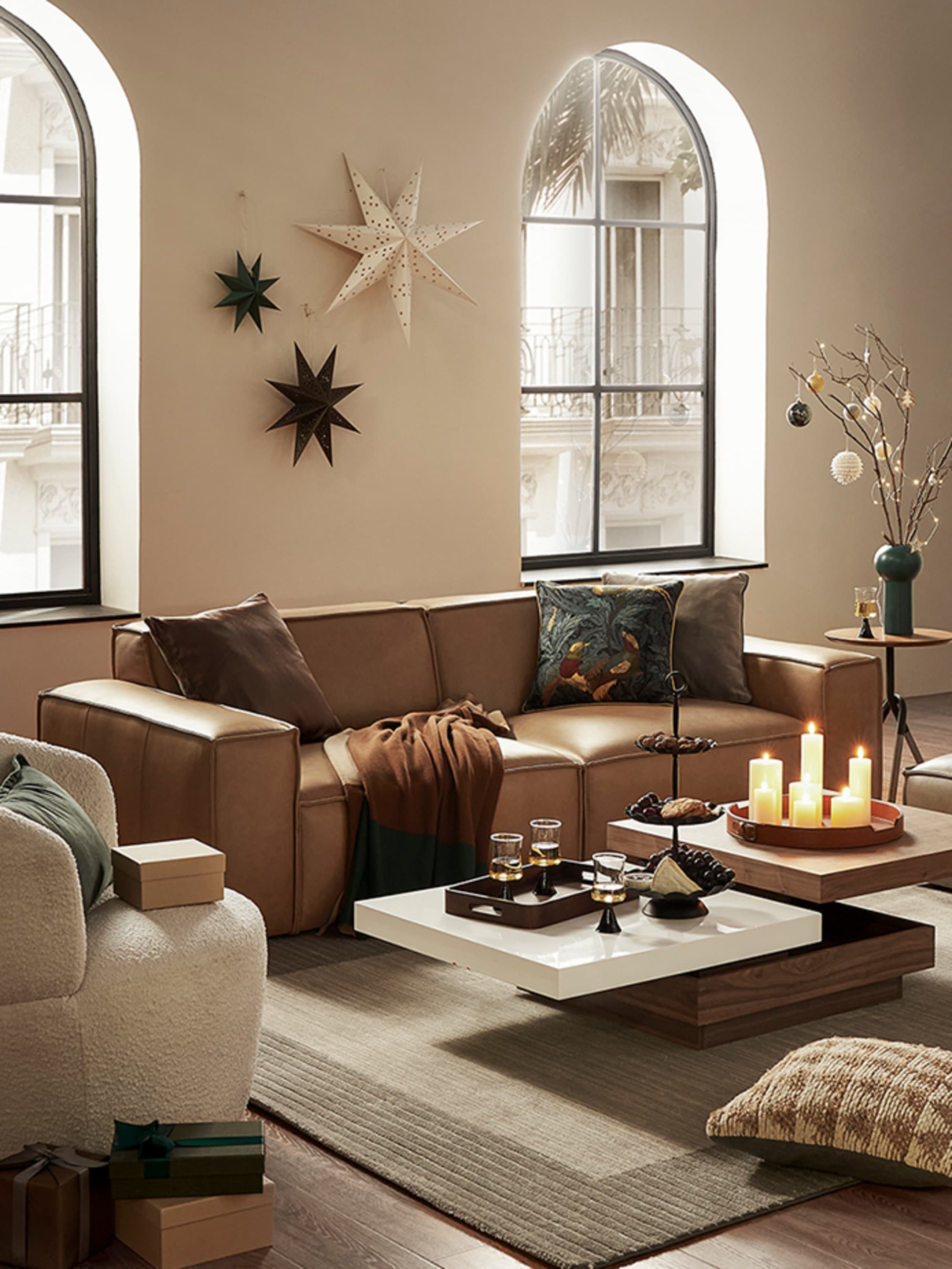 A leather sofa and a performance fabric armchair placed in a living room.