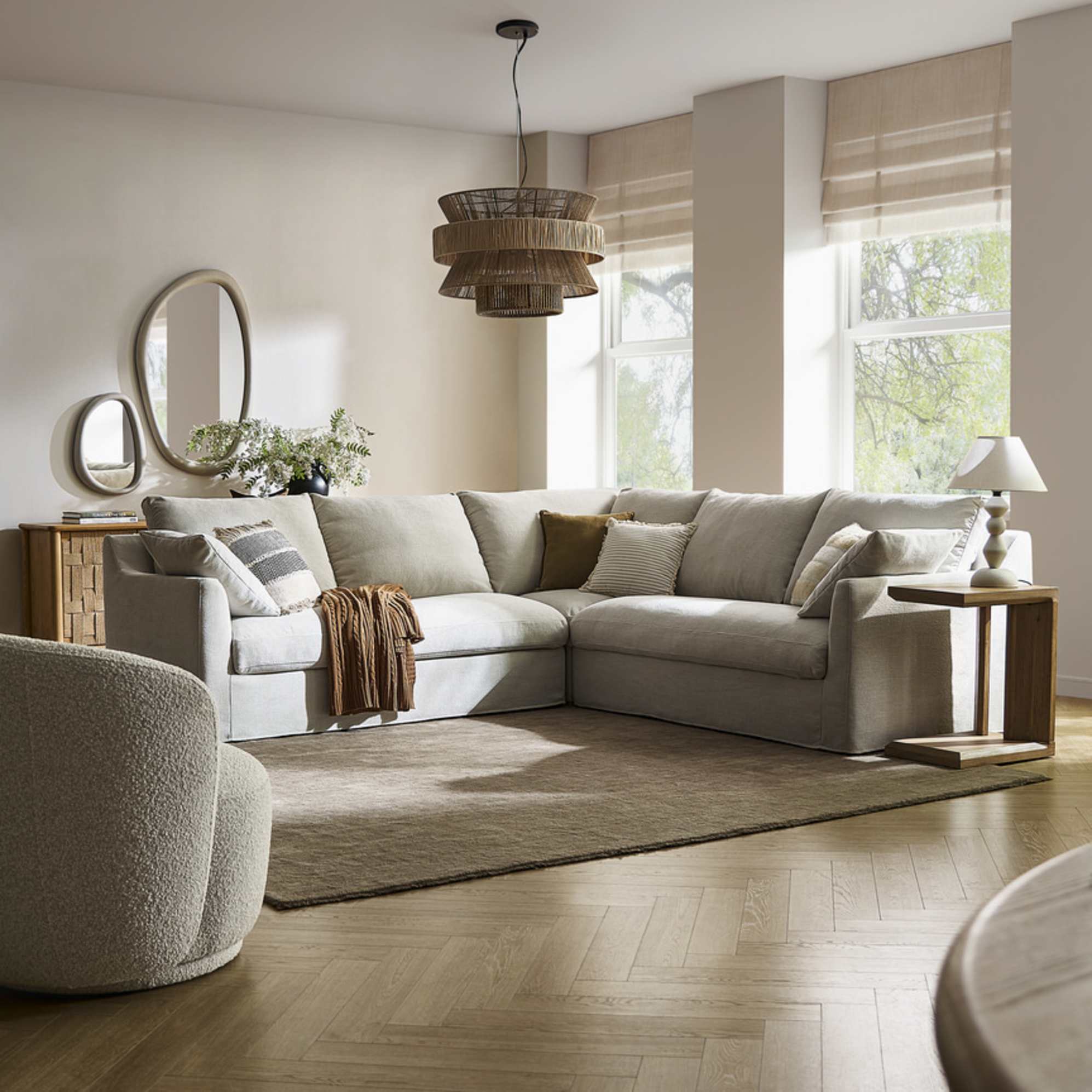 A white slipcover storage l-shape sectional sofa placed in a living room atop an area rug.