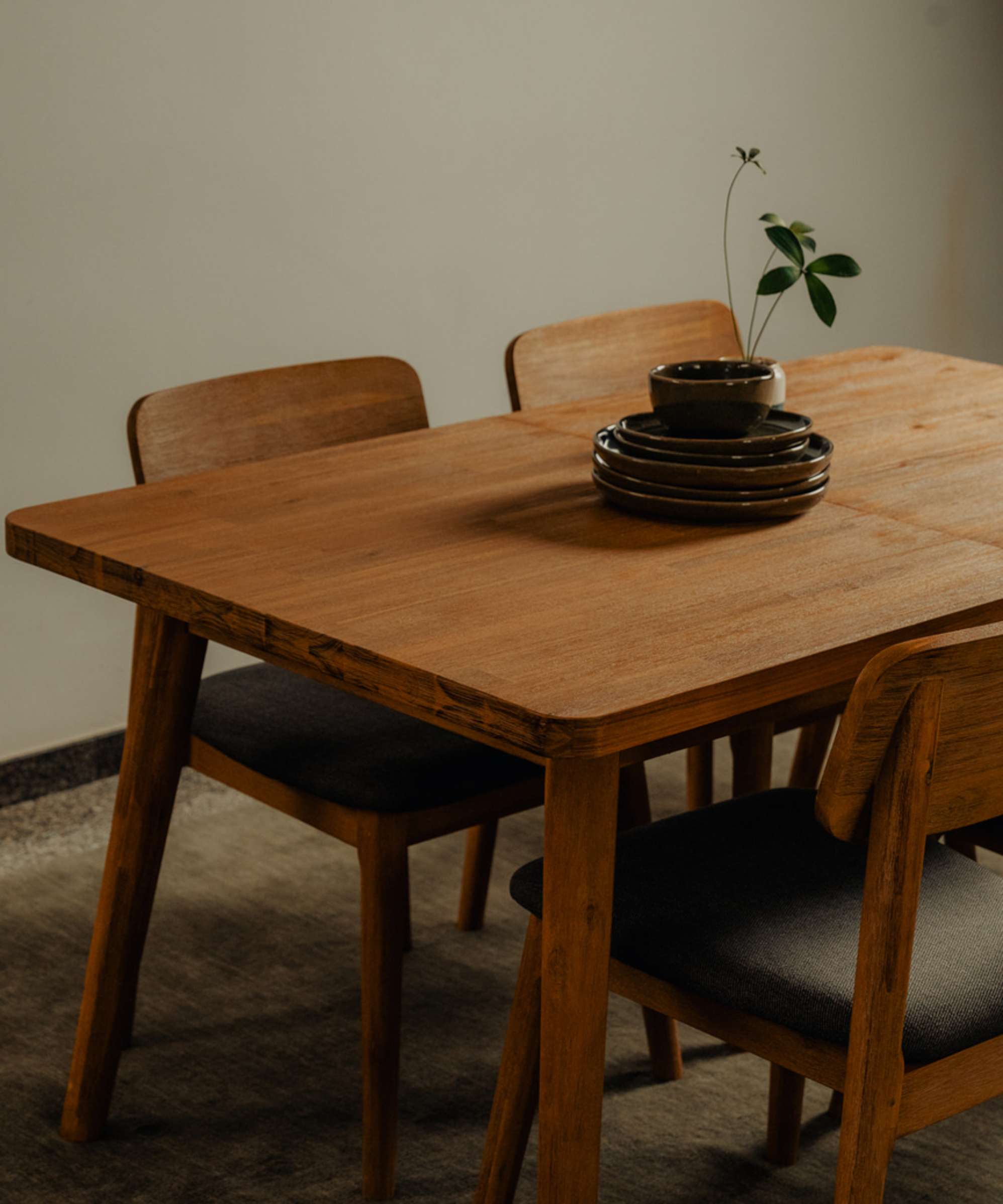 An acacia wood extendable dining table with matching acacia wood diningchairs.
