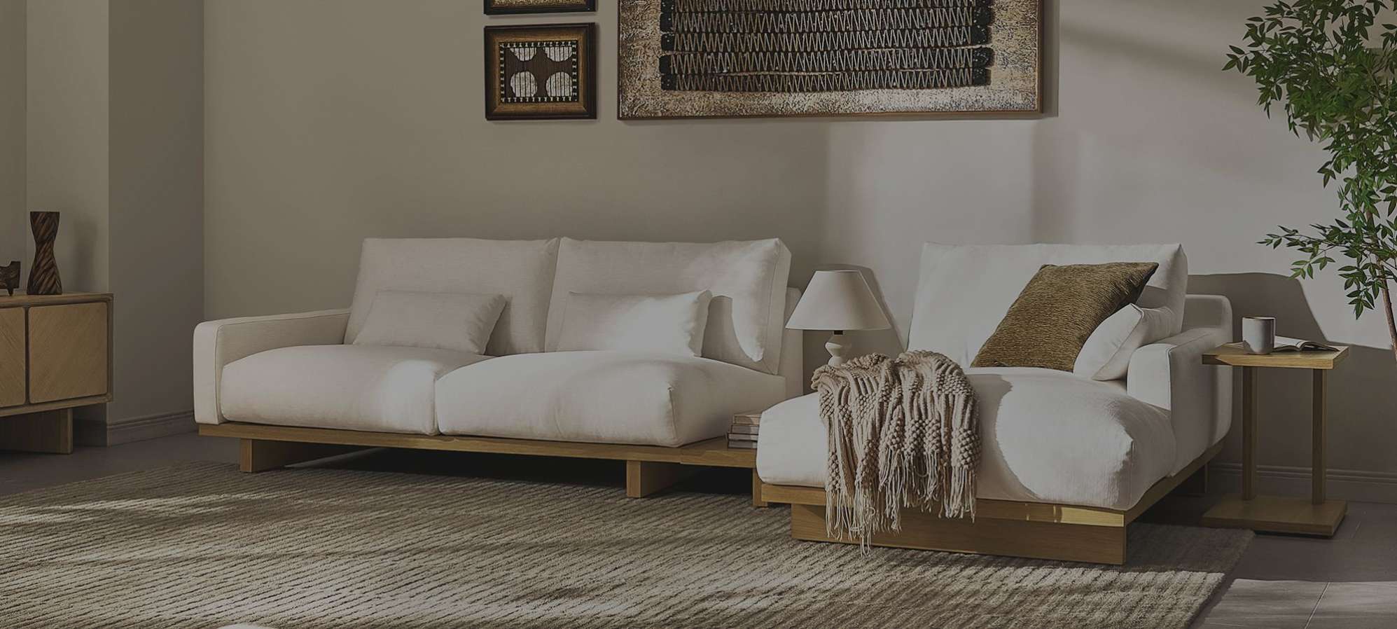 A white modular performance fabric sofa with a brown throw.
