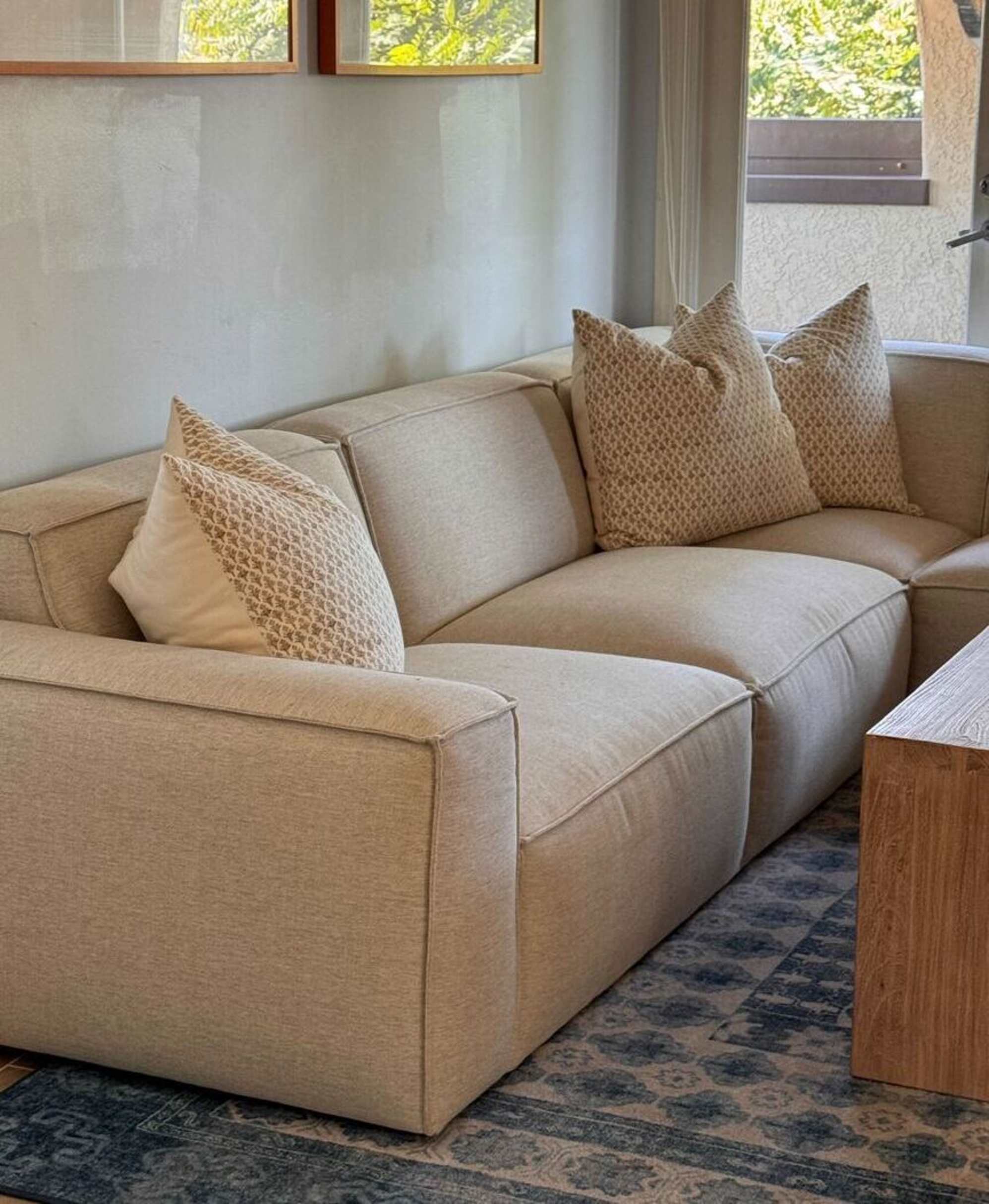 An extended side chaise sectional sofa placed in the corner of a living room.