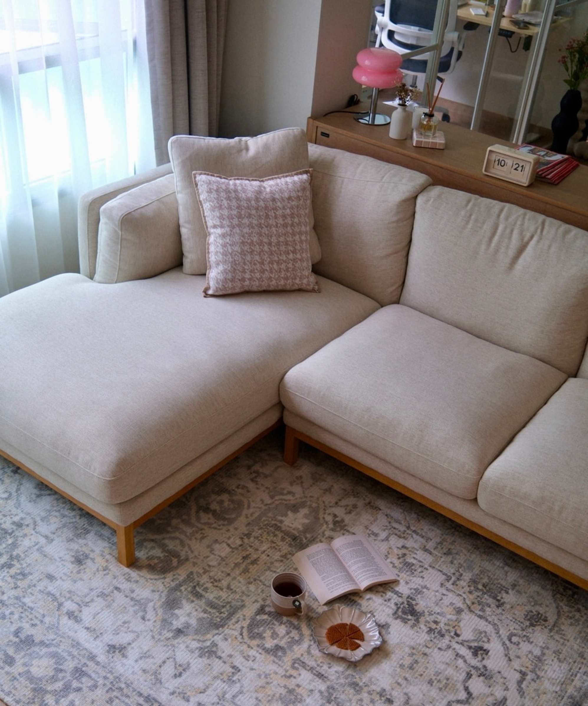 A chaise sectional sofa placed on an ornate area rug.
